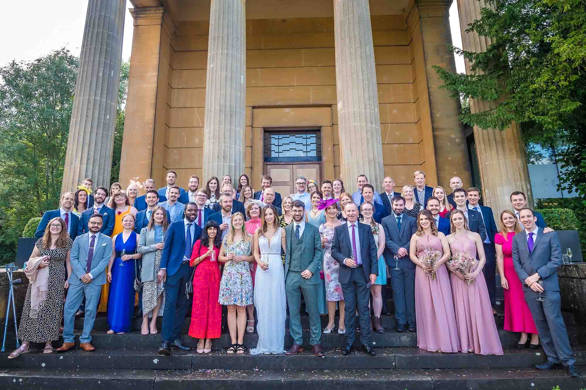 Whole wedding party outside the Spielman Centre in Arnos Vale