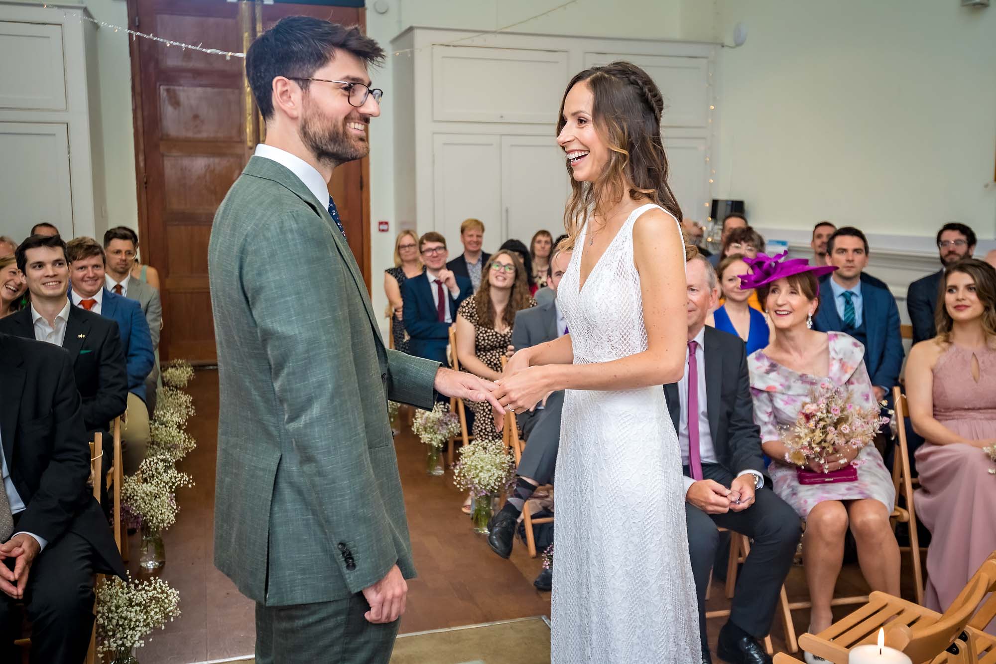 Bride and groom laughing during the rings exchange at Arnos Vale