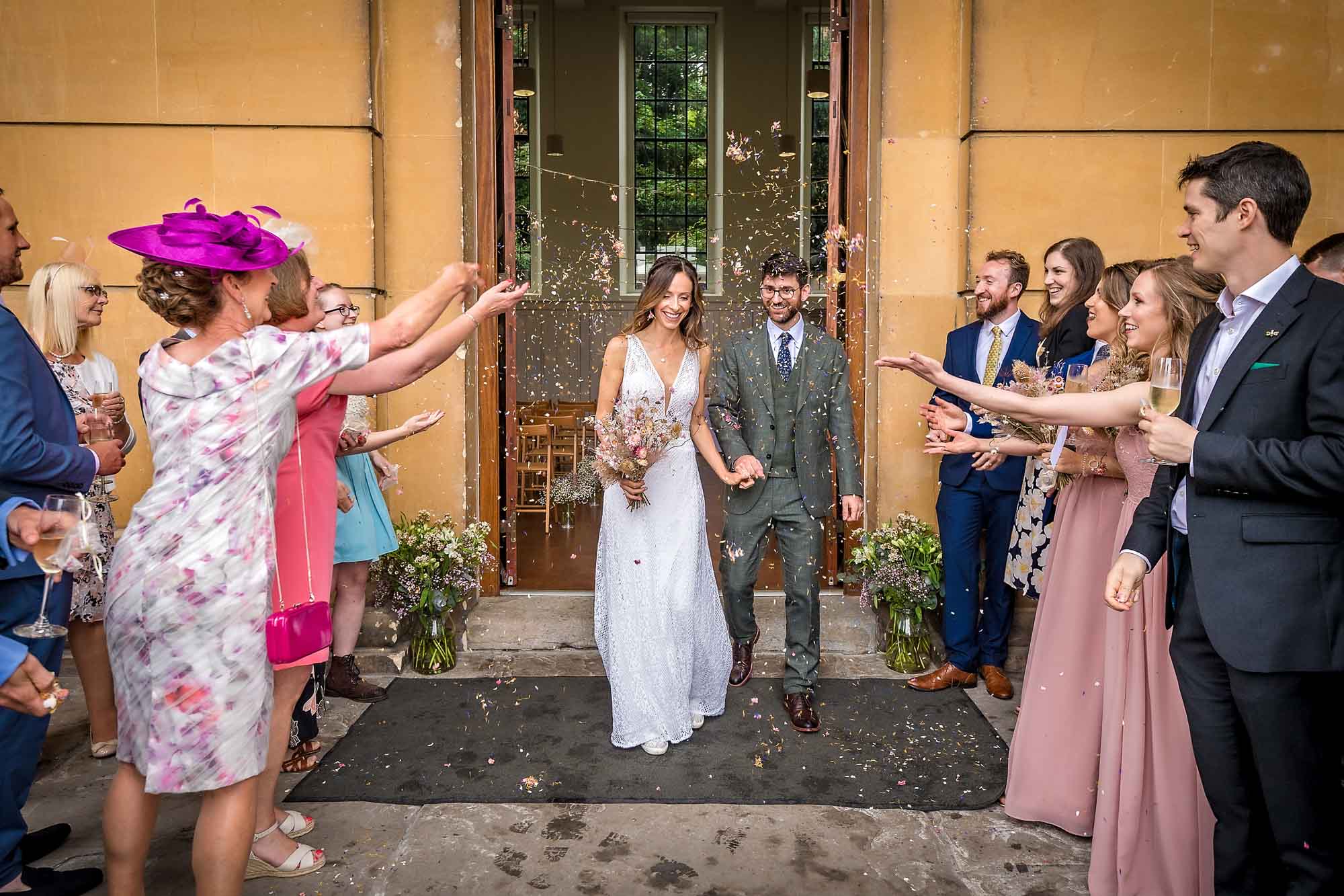 Wedding confetti shower as couple exit the Spielman Centre at Arnos Vale