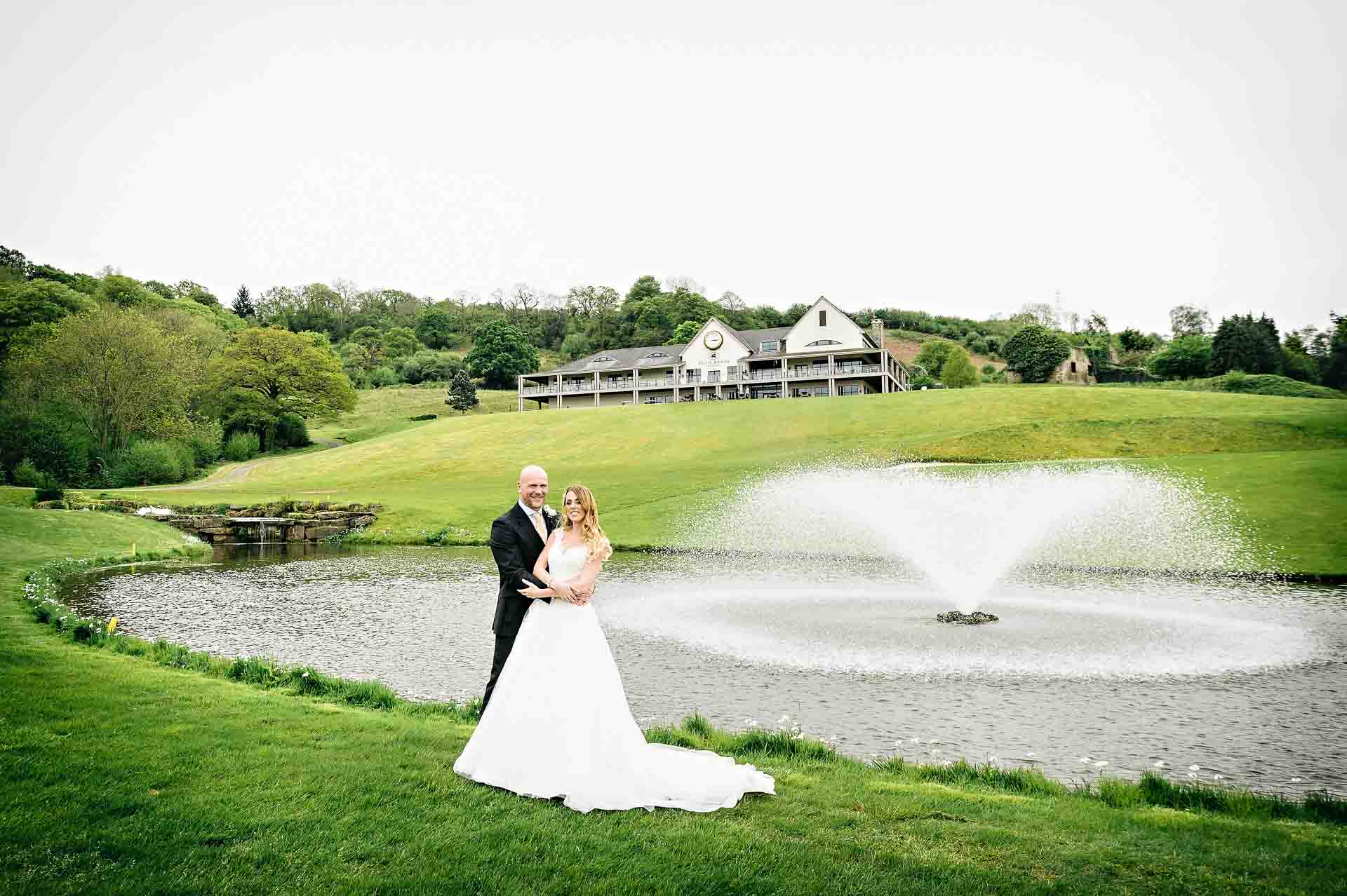 Wedding Portrait of Couple with Twenty Ten Clubhouse, Celtic Manor Resort in Background.