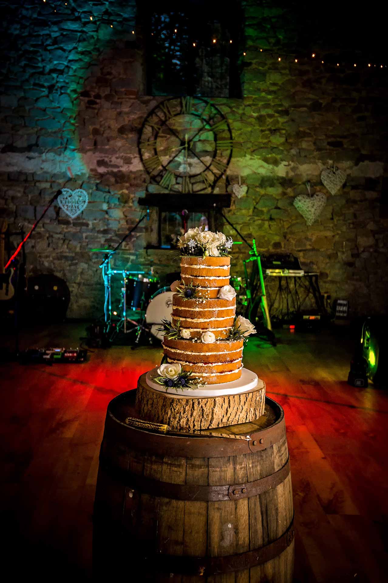 Wedding cake displayed on beer barrel in Old Barn, Pencoed House Estate