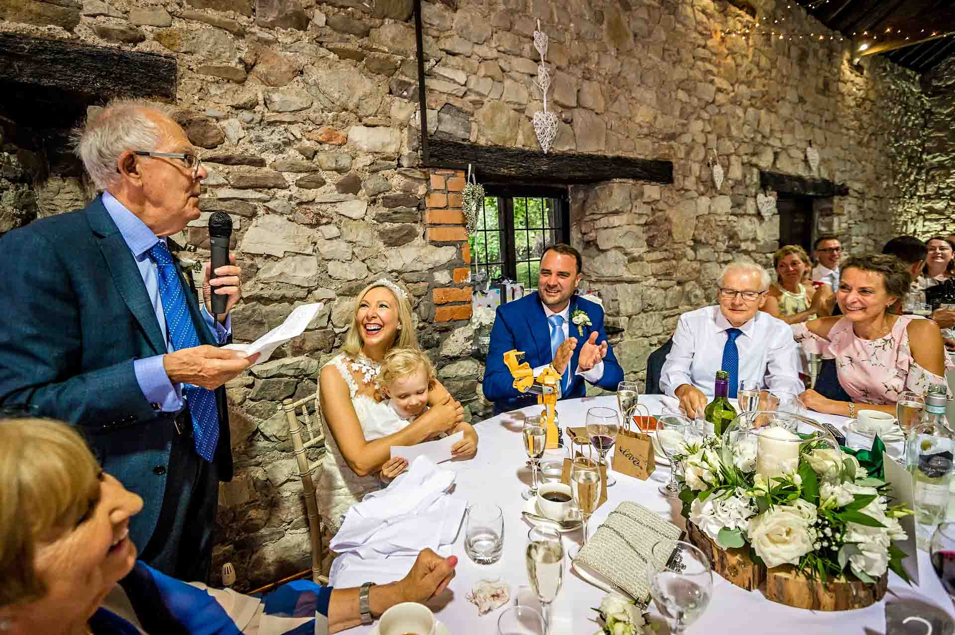 Father of bride giving speech in old barn ad Pencoed House in Cardiff