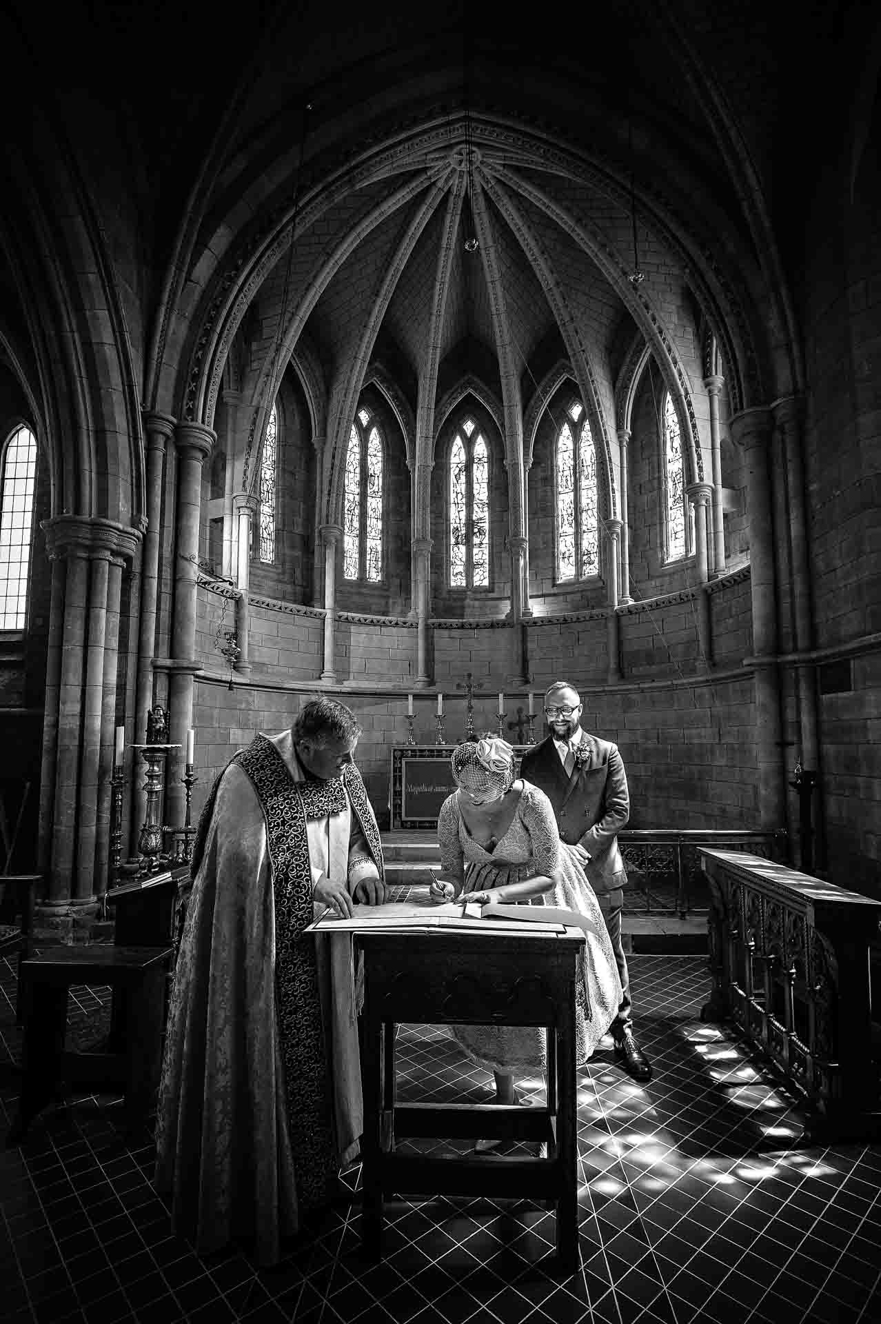 Bride signing register in church in Crystal Palace