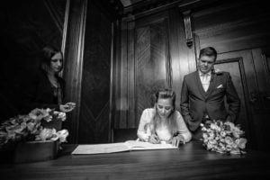Bride signing wedding register at venue in London