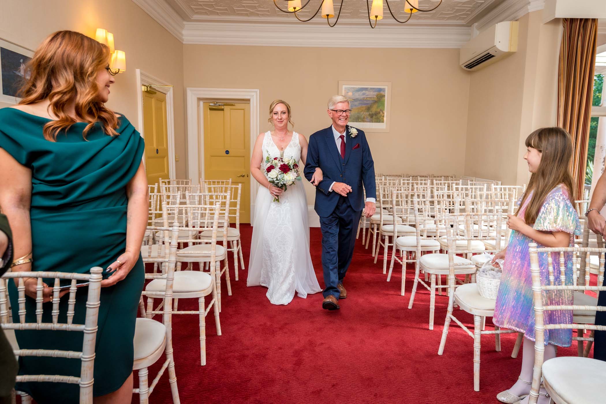 Bride and her Father walking down the aisle of the Liscombe Room at Newport Register Office