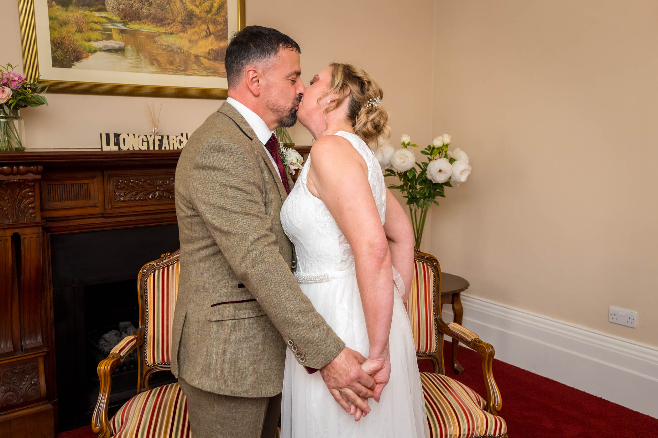 Couple kissing after their exchange of rings at Newport wedding in Wales