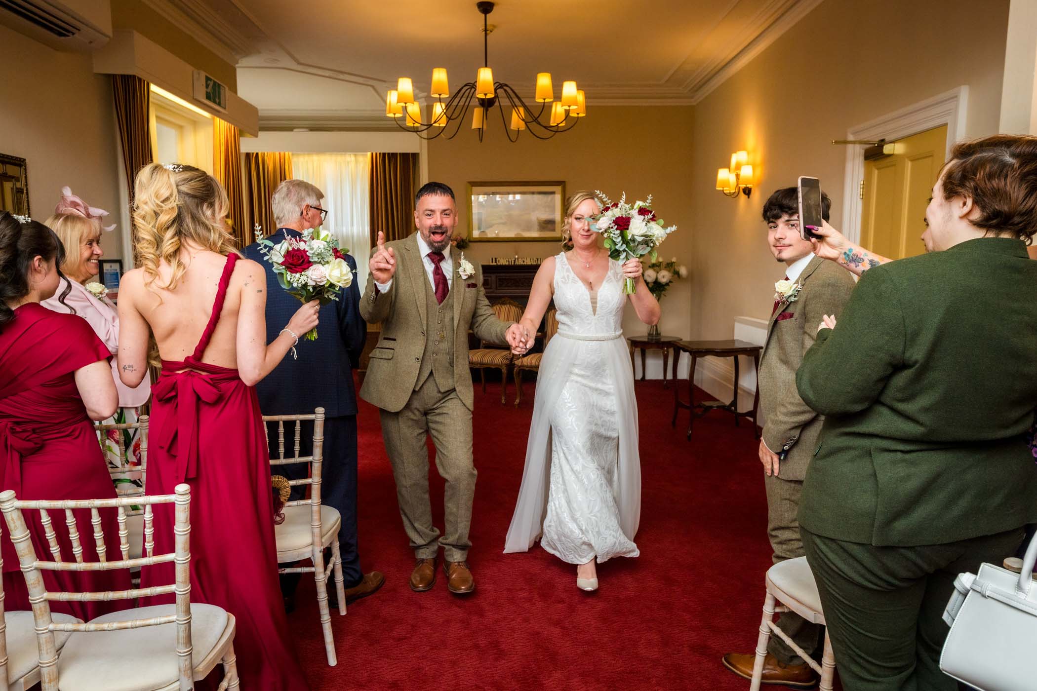 Newlyweds walking back up the aisle after their wedding at the Newport Register Office