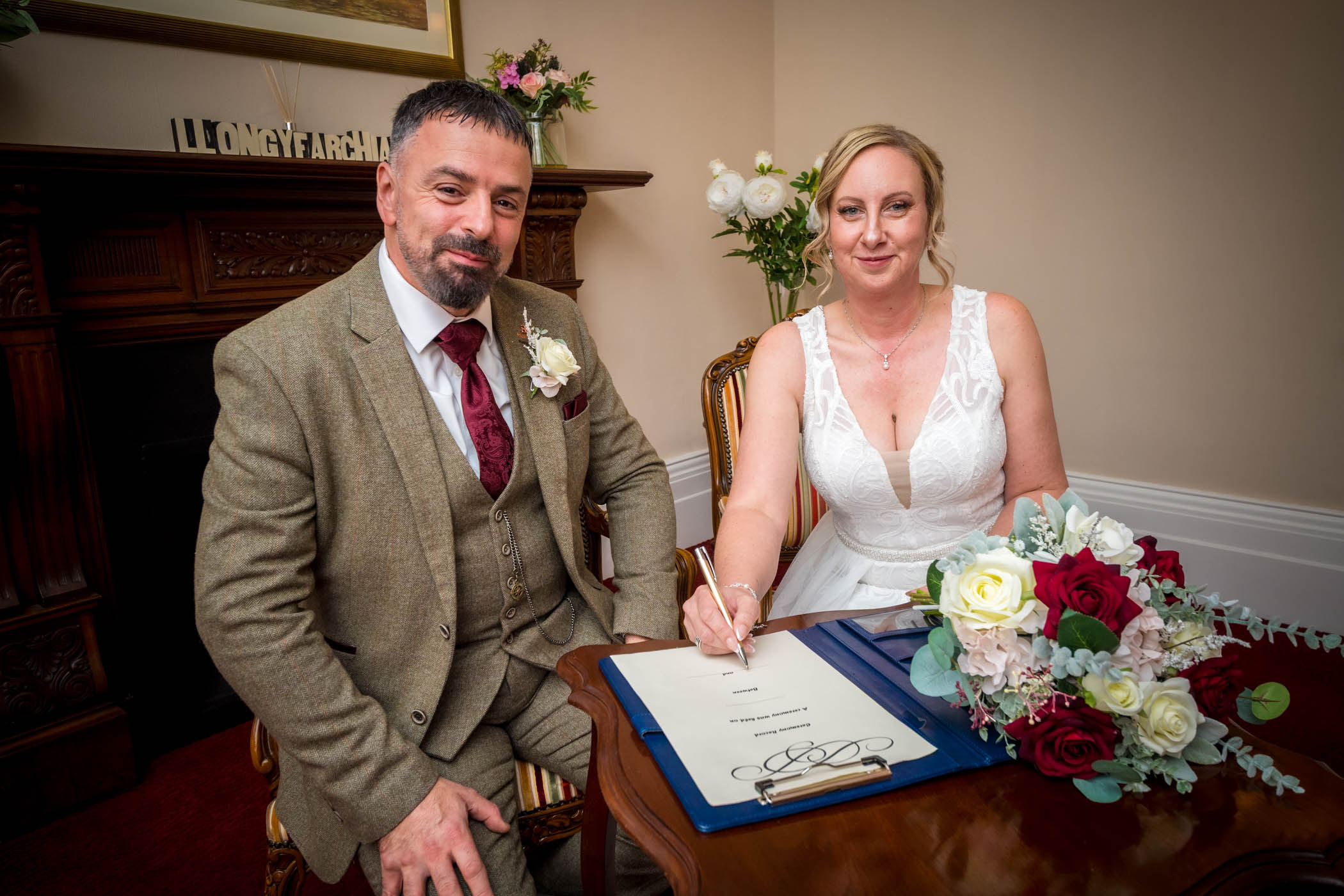 The newlyweds pose for the camera after the signing of the wedding schedule