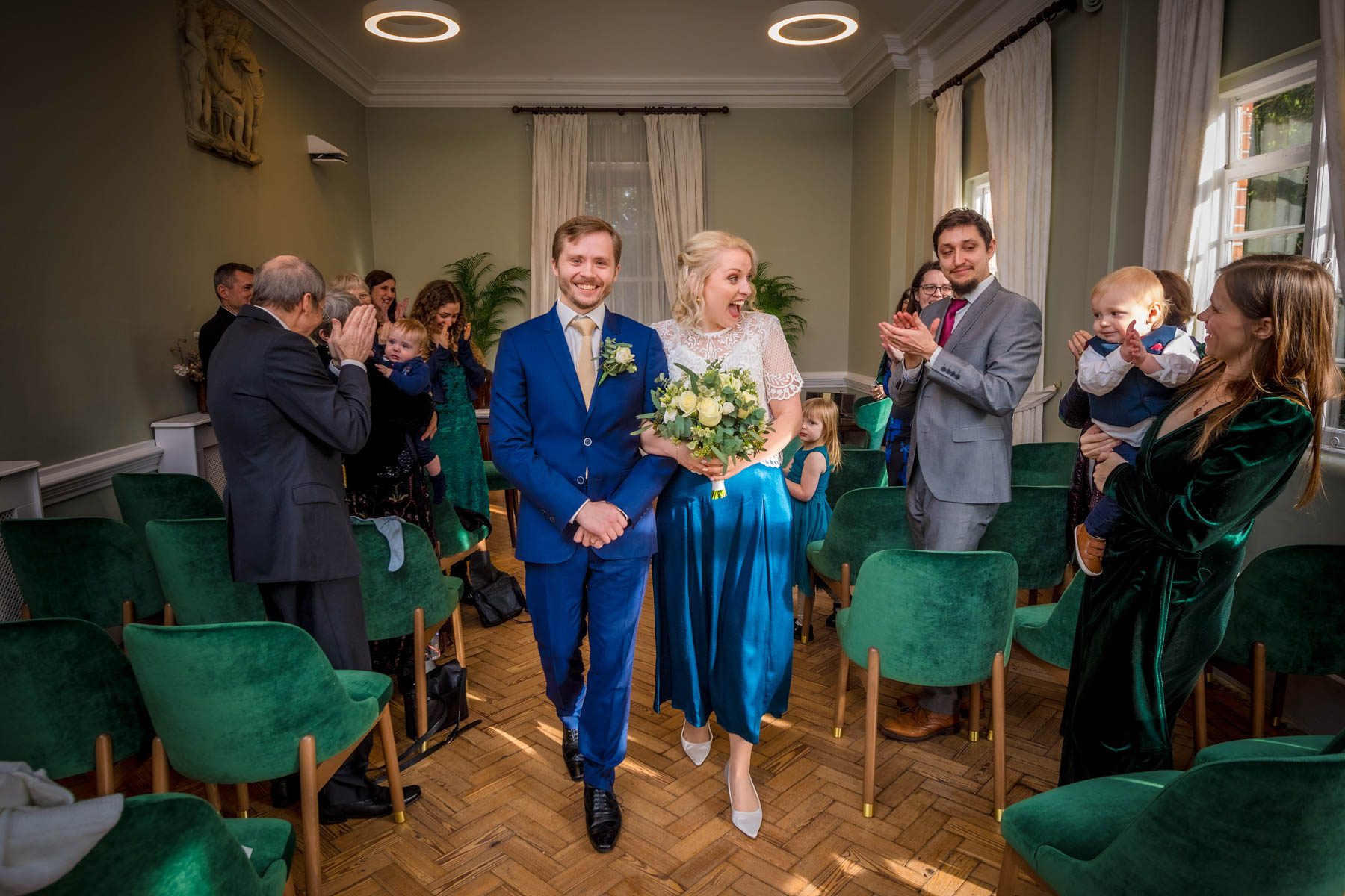 Couple walking back down the aisle after their wedding ceremony in South London.