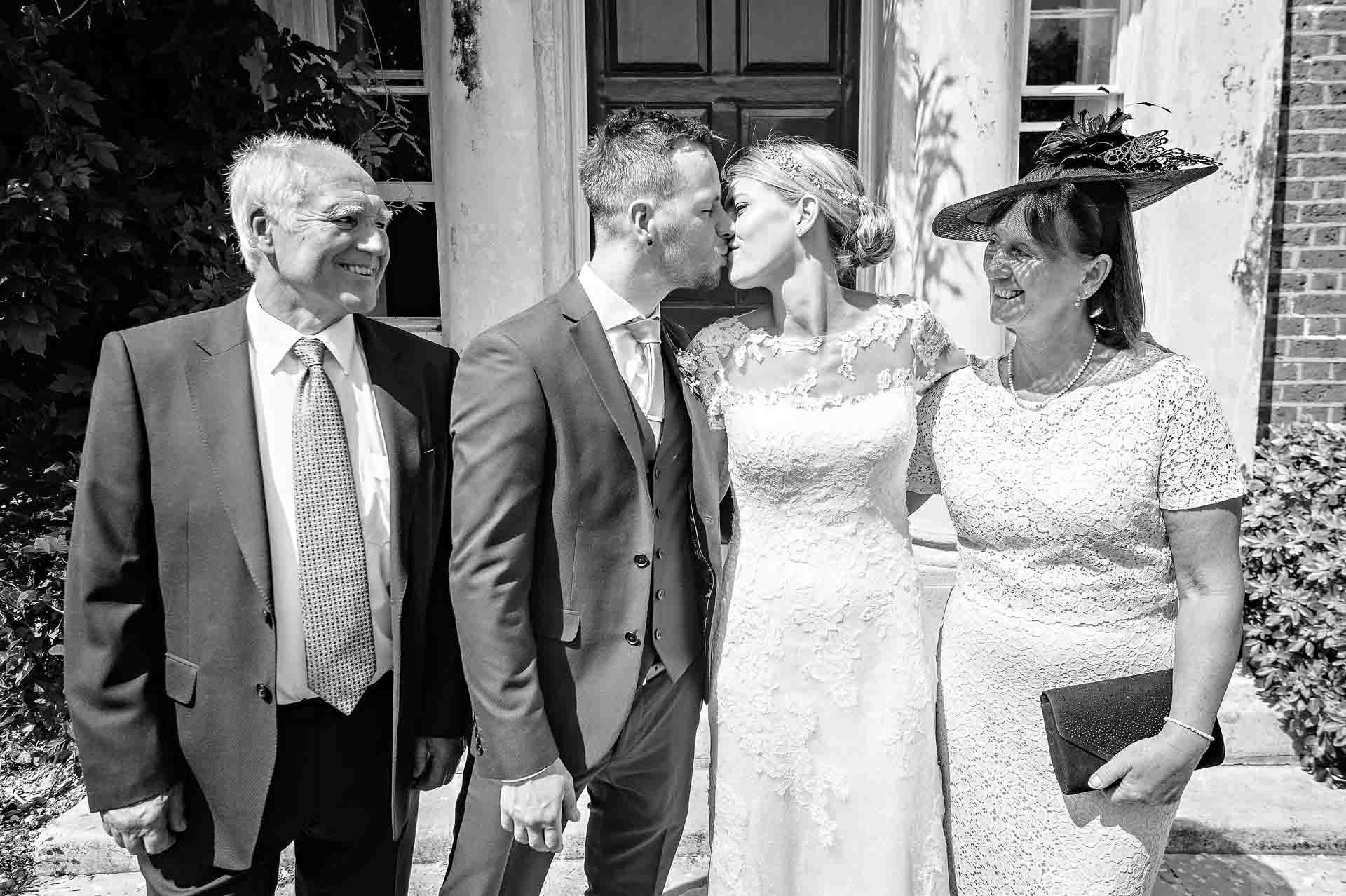 Bride and Groom Kissing During Group Shots