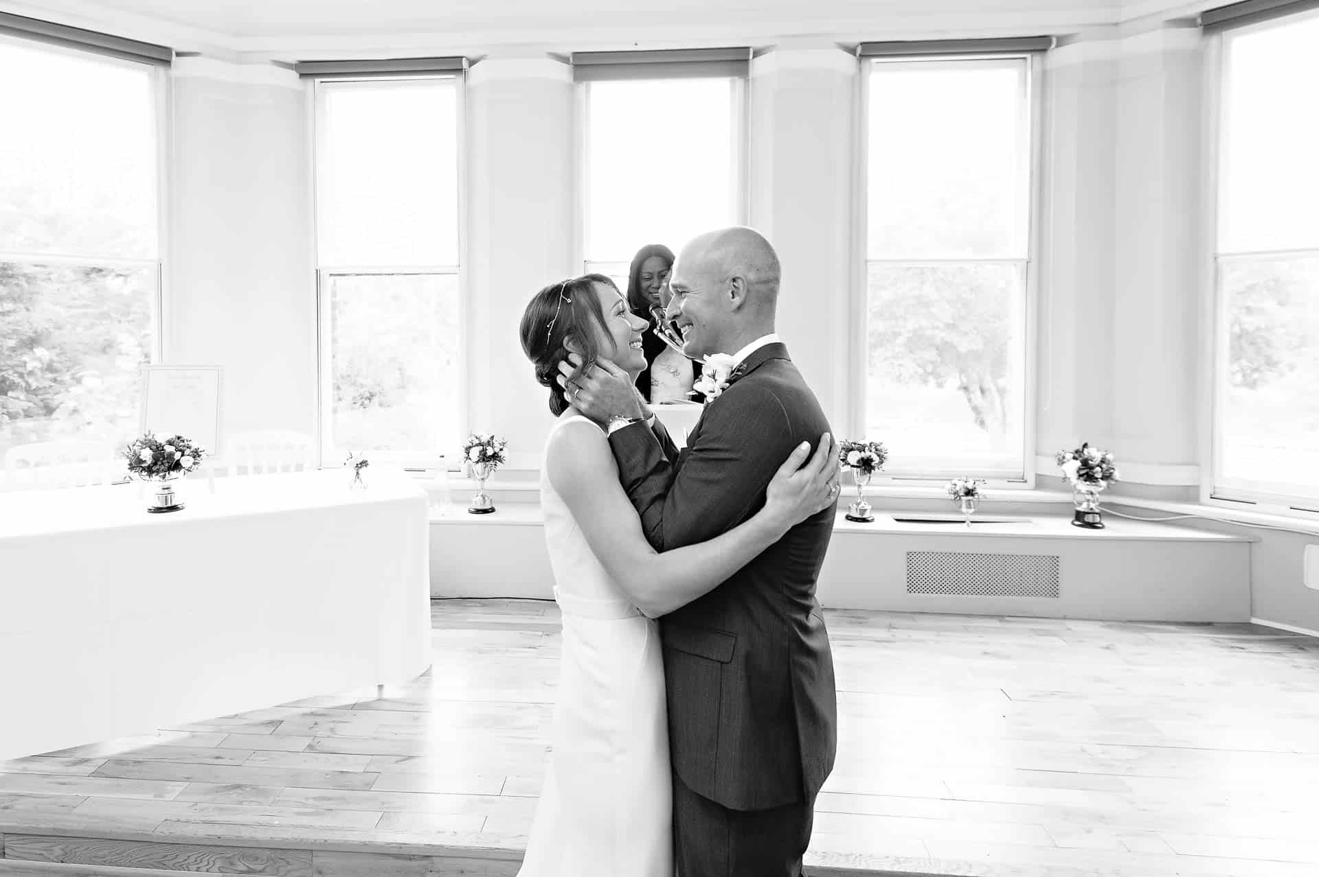 Bride and Groom Looking Lovingly at Each Other in Caerphilly Caerphilly Wedding Photographer - Loving Wedding Couple Holding Each Other at Marriage Ceremony