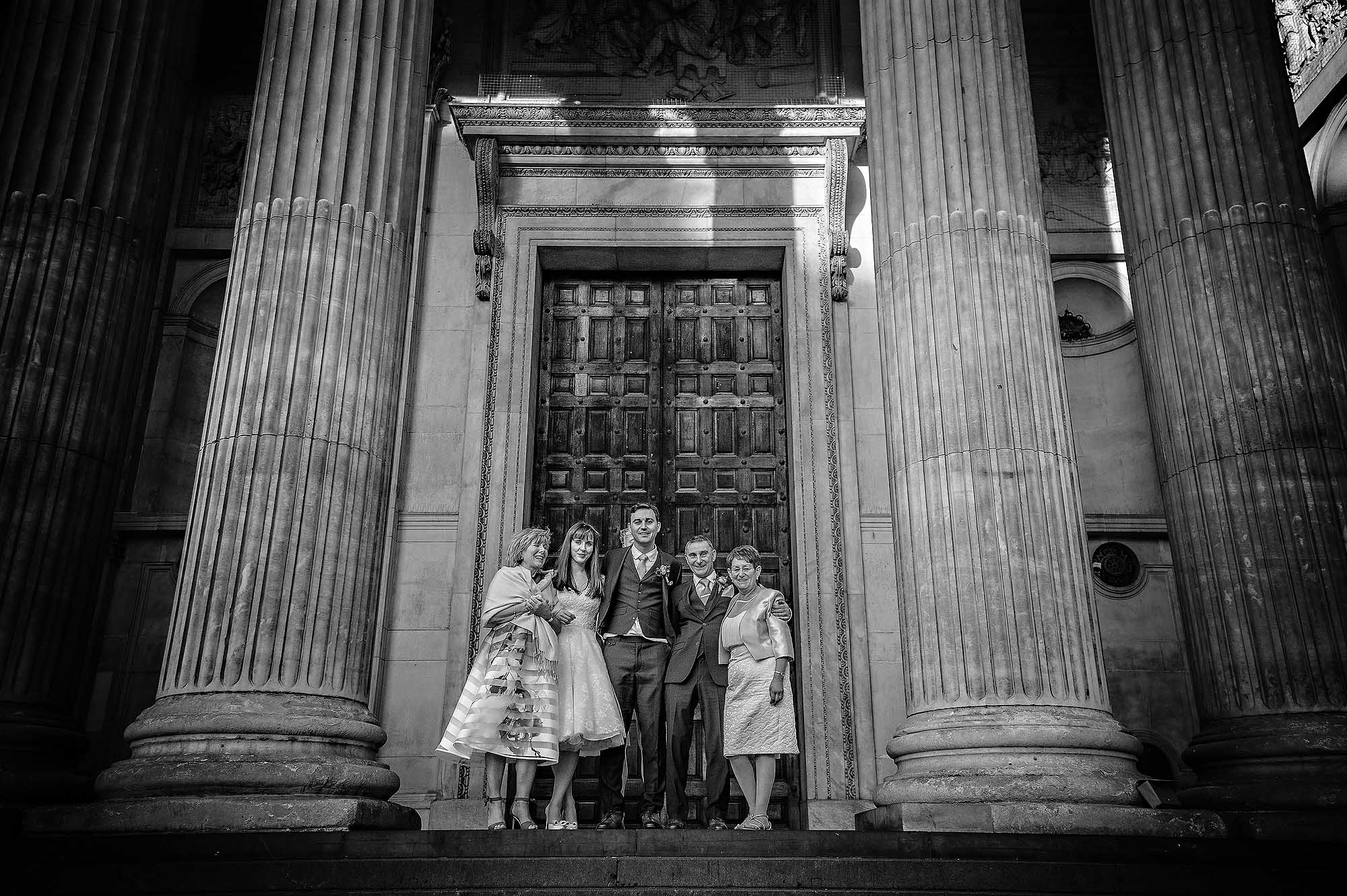Black and White Wedding Portrait Taken Outside St Paul's Cathedral of Family St Paul's Cathedral Wedding Portrait of Family Outside Doors