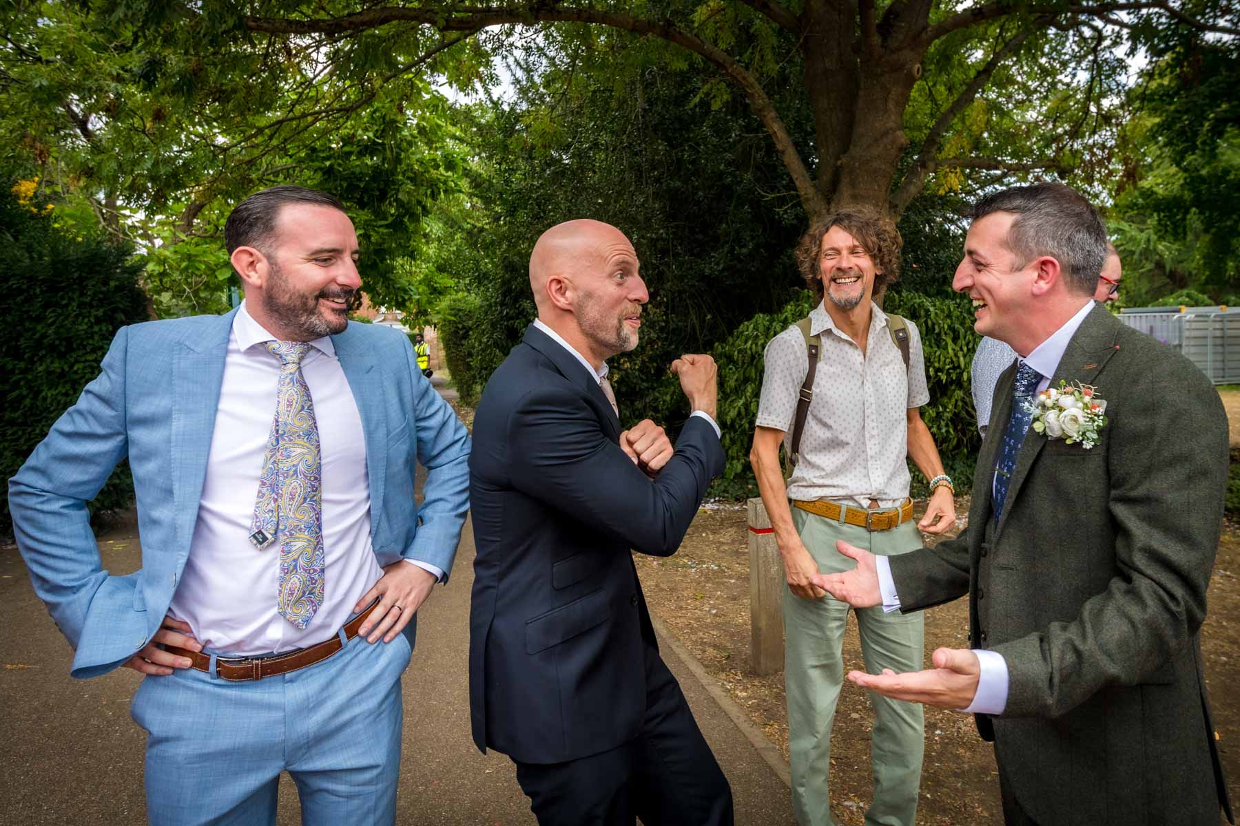 Man pumping his arm to groom in appreciation of the bride at wedding near London