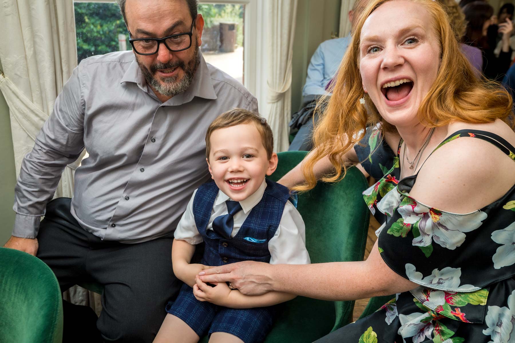 Parents with toddler before wedding with mum and toddler laughing