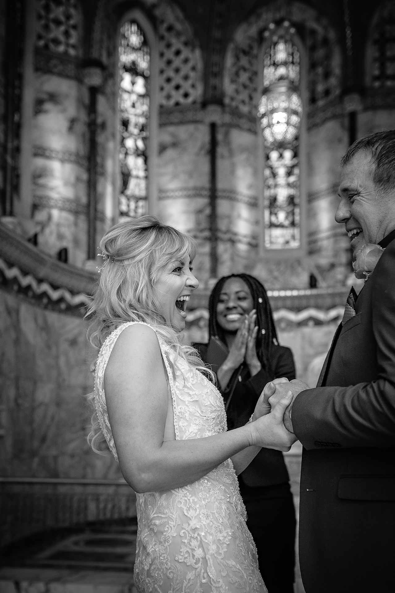 Bride cheering as she is married at Fitzrovia Chapel
