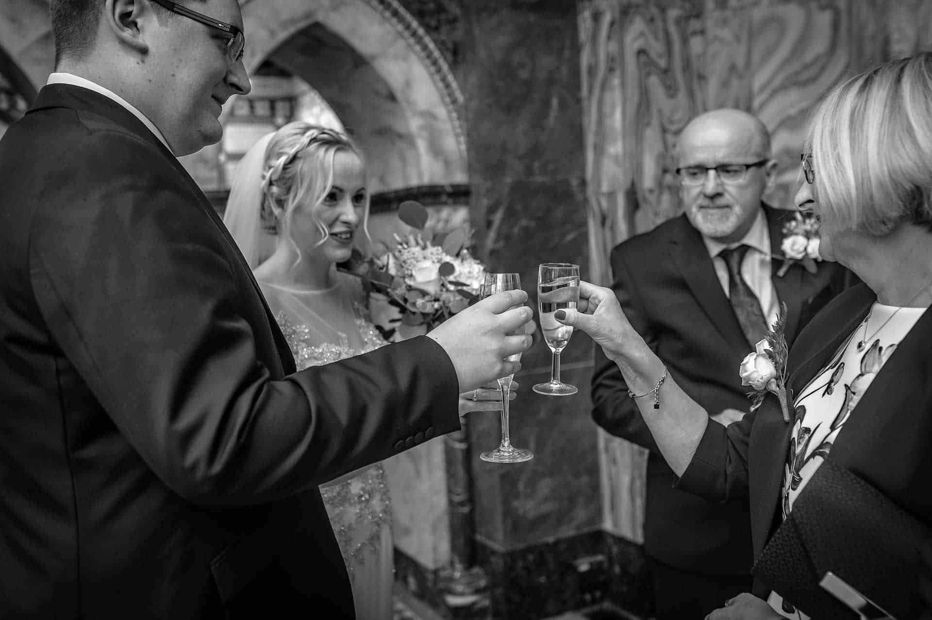 Wedding guests toasting the Bride and Groom at London Wedding - black and white