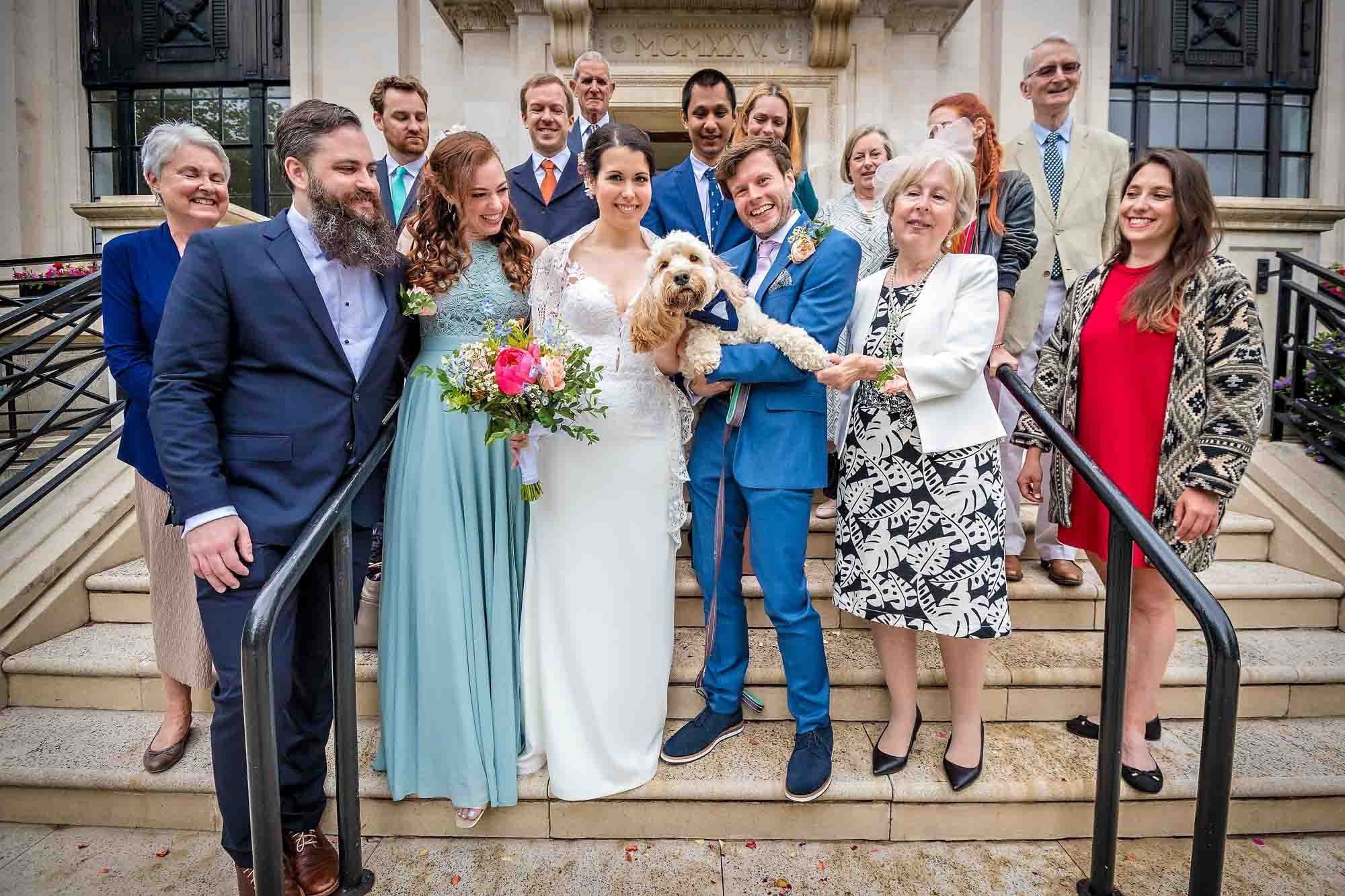 The couple pose with their family, friends and dog outside Islington Town Hall