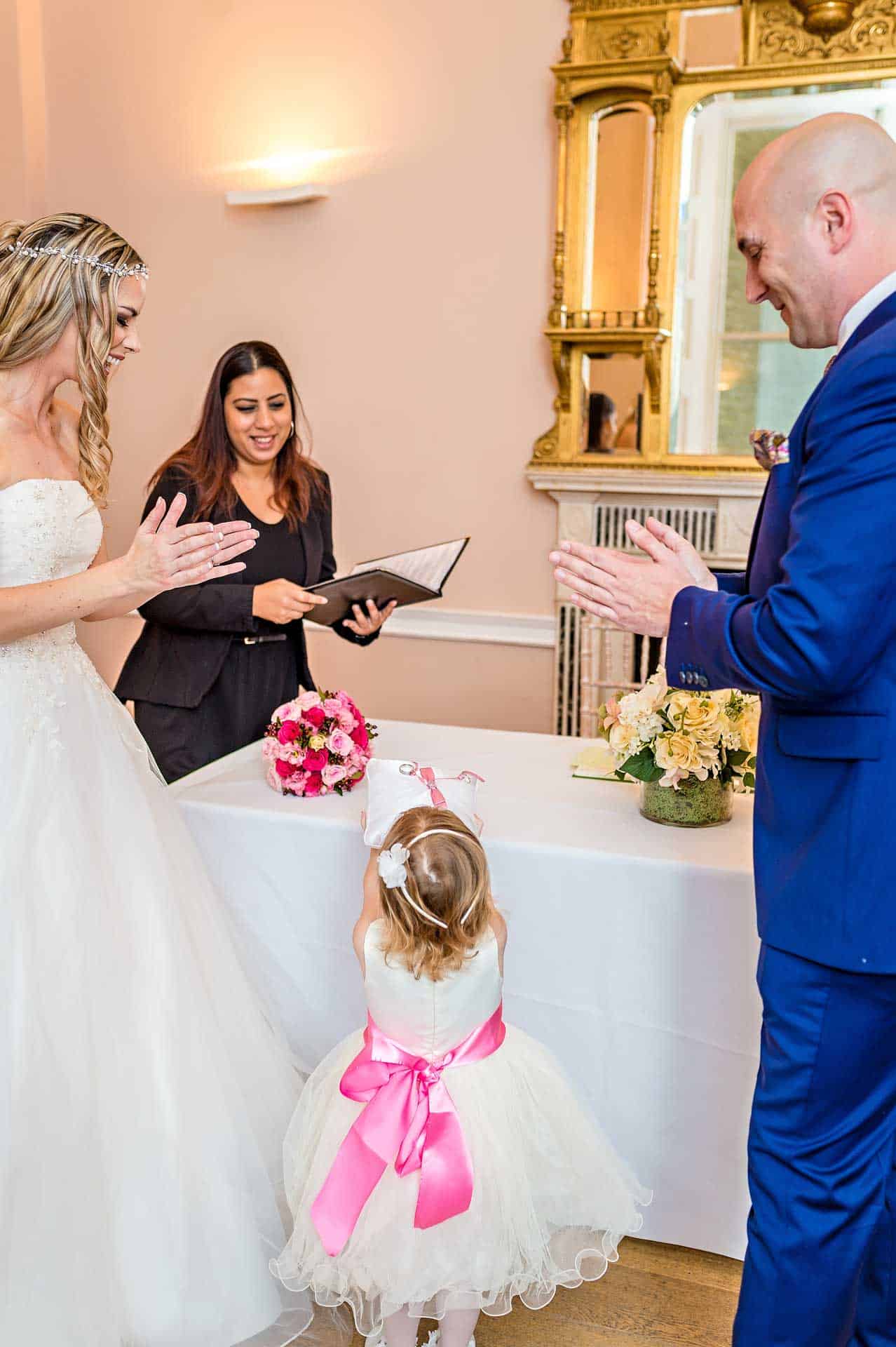 Bridesmaid Giving Rings to Registrar at Wedding in Asia House