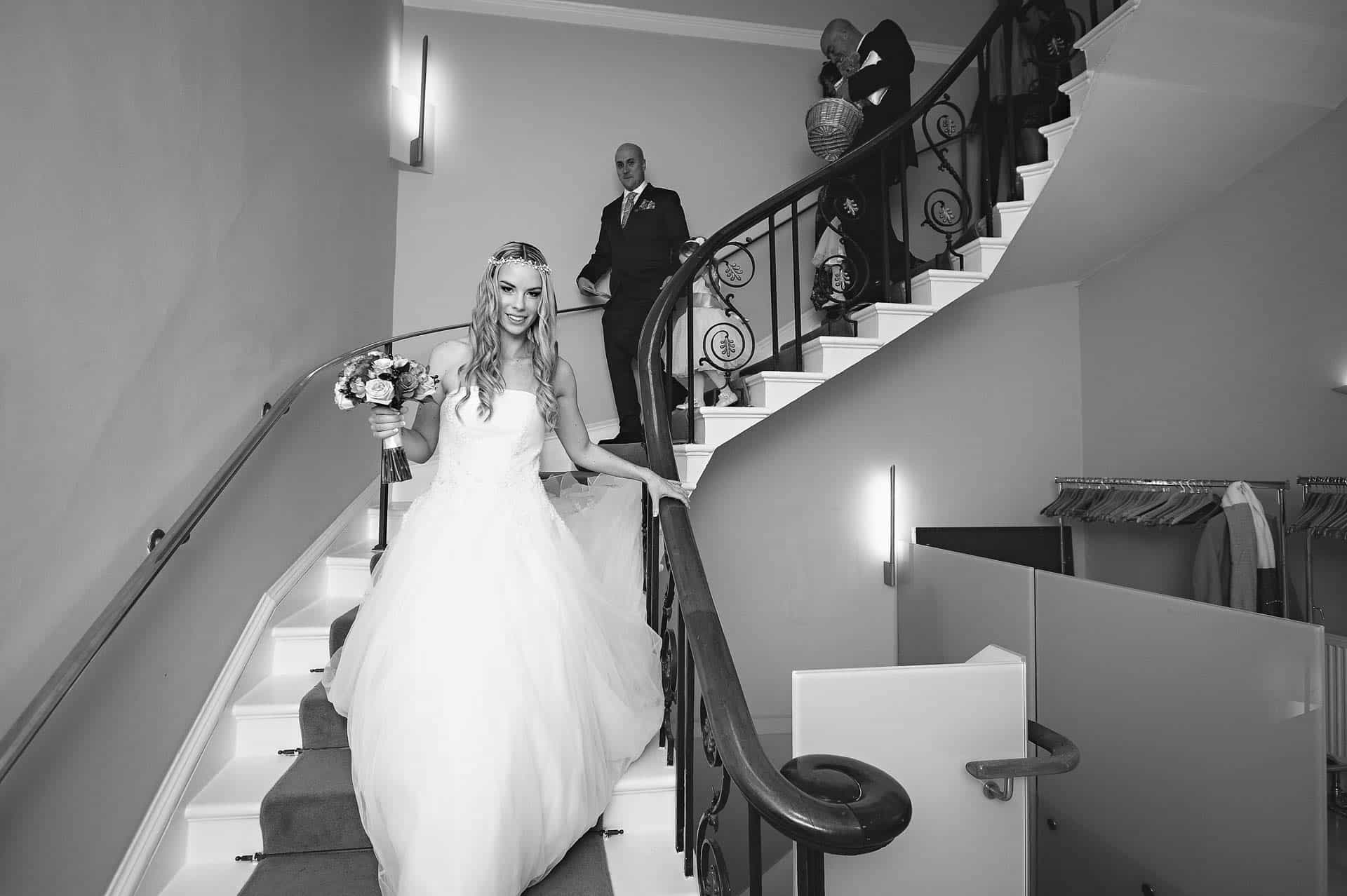 Asia House Wedding Photography - Bride and Groom descending stairs