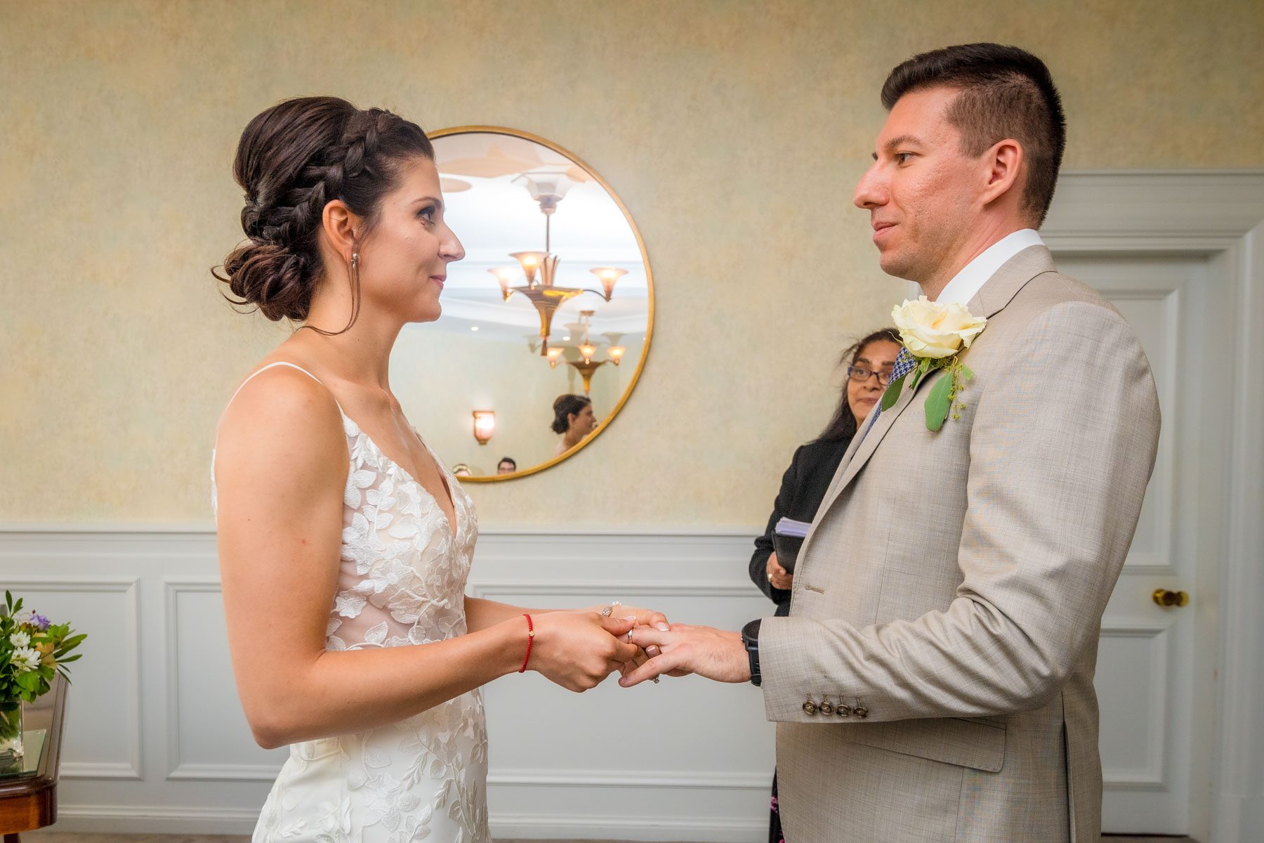 Couple exchanging rings and looking into each others eyes