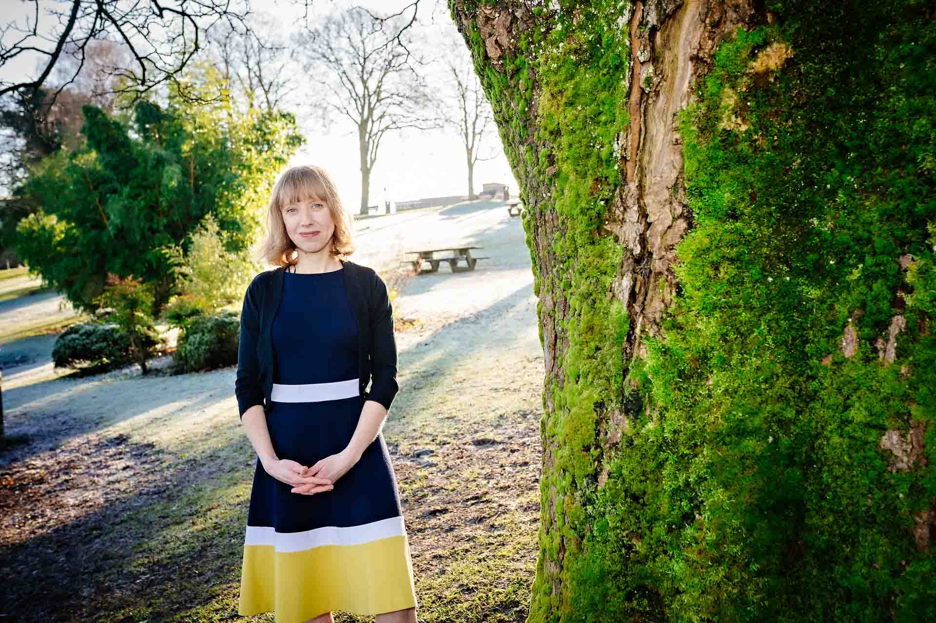 Lady standing next to tree in Cardiff sunshine