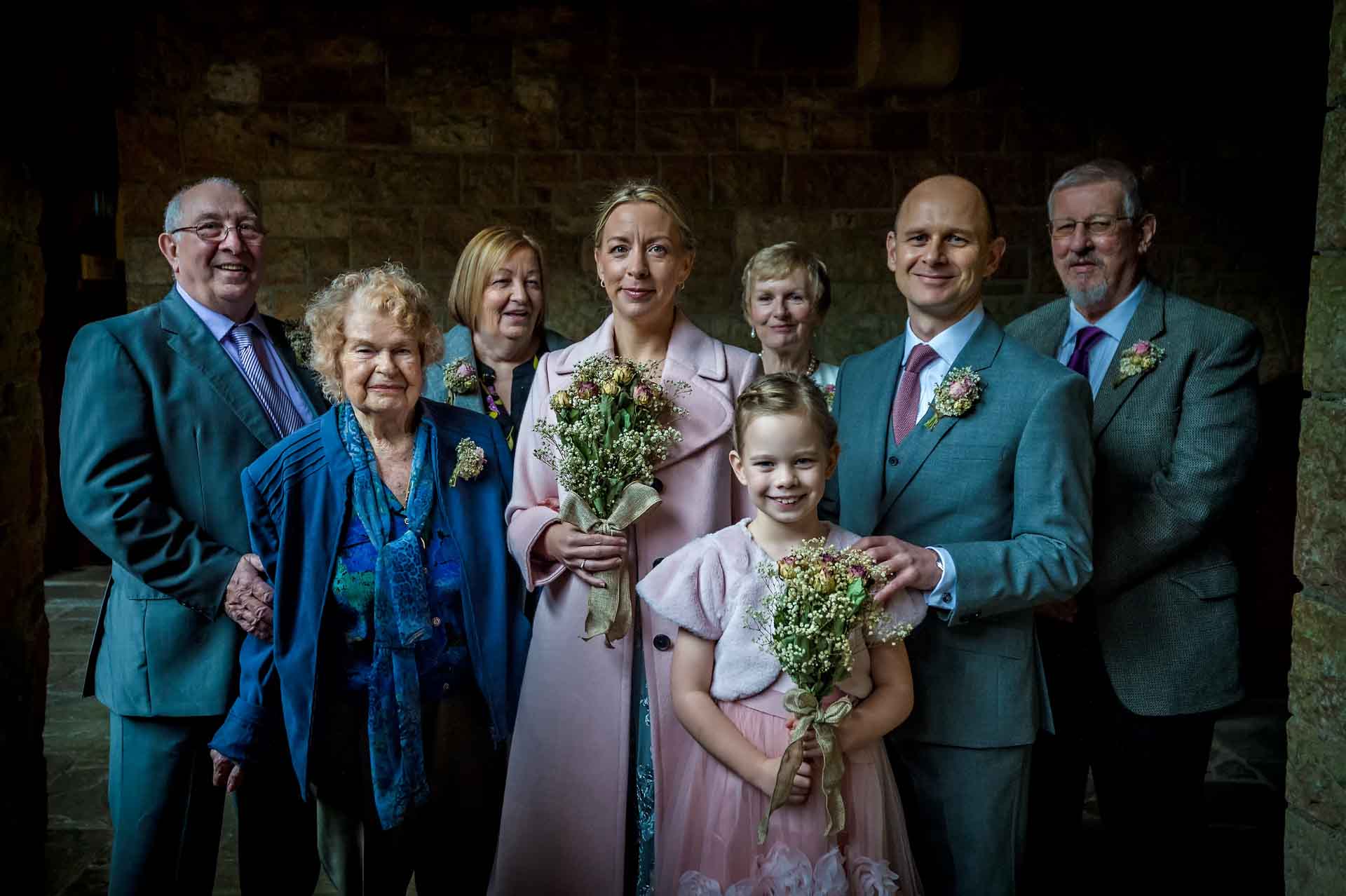Family wedding portrait in subdued light taken at Castell Coch