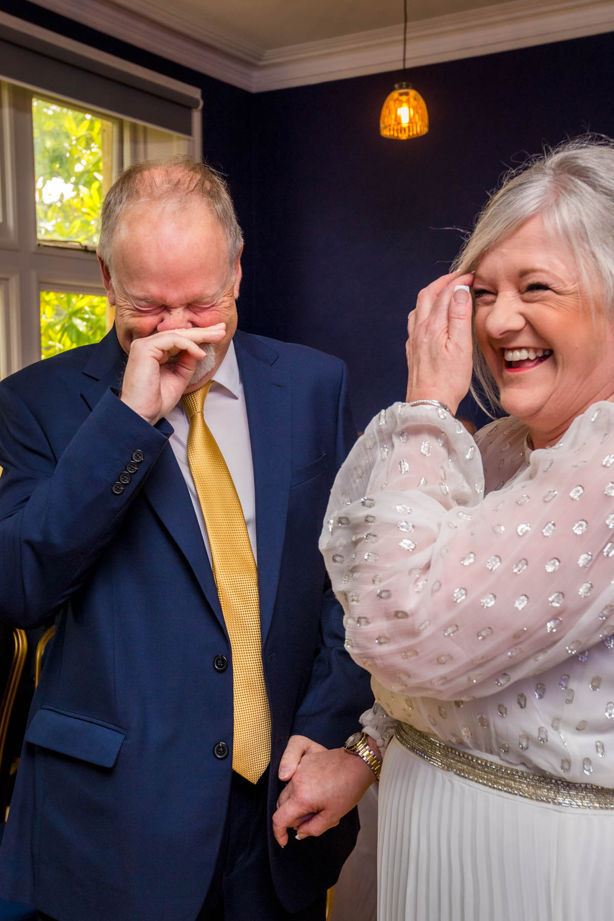 Bride and groom laughing during their wedding ceremony at Insole Court
