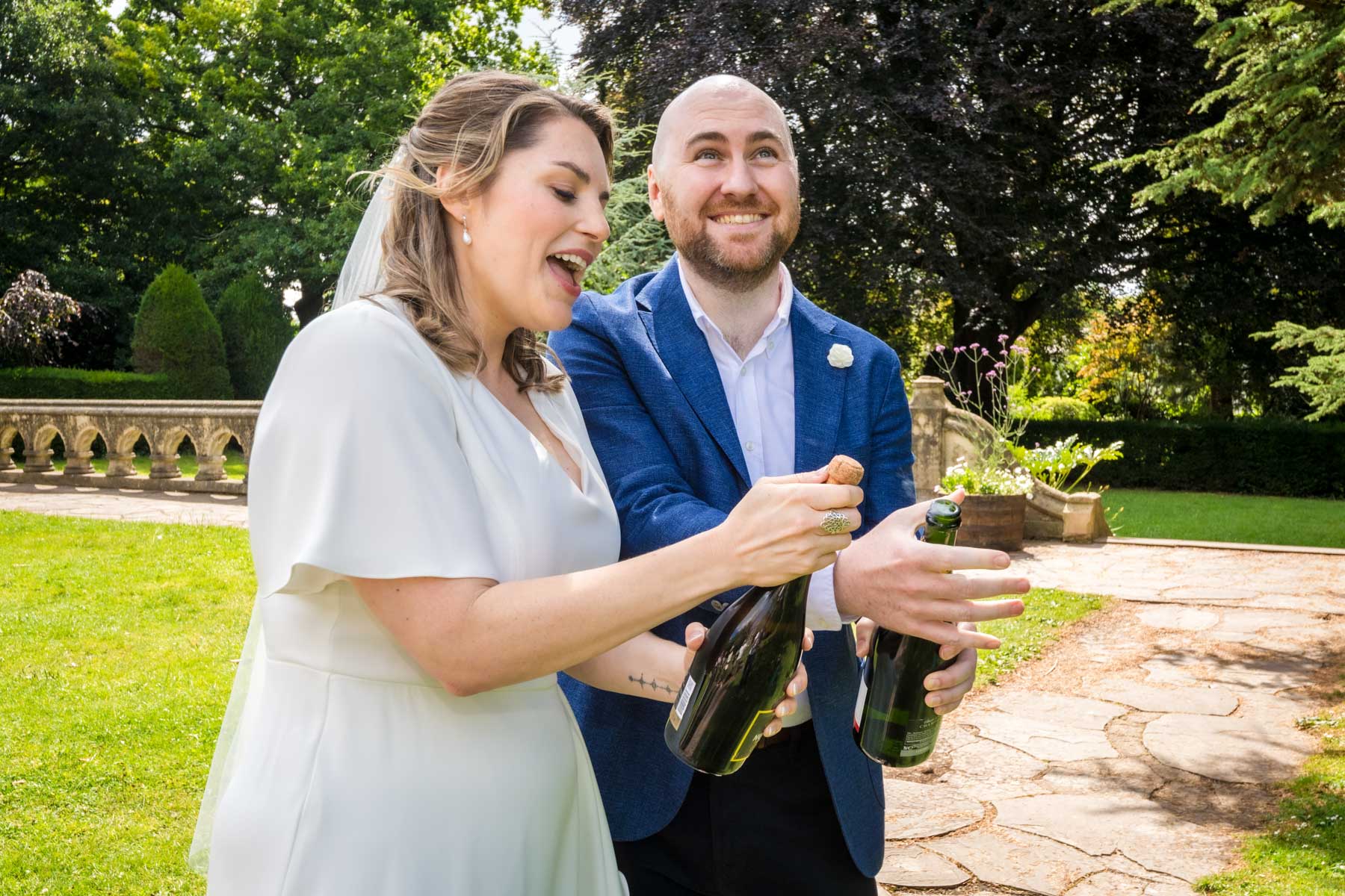 Newlyweds pop champagne corks after their wedding ceremony