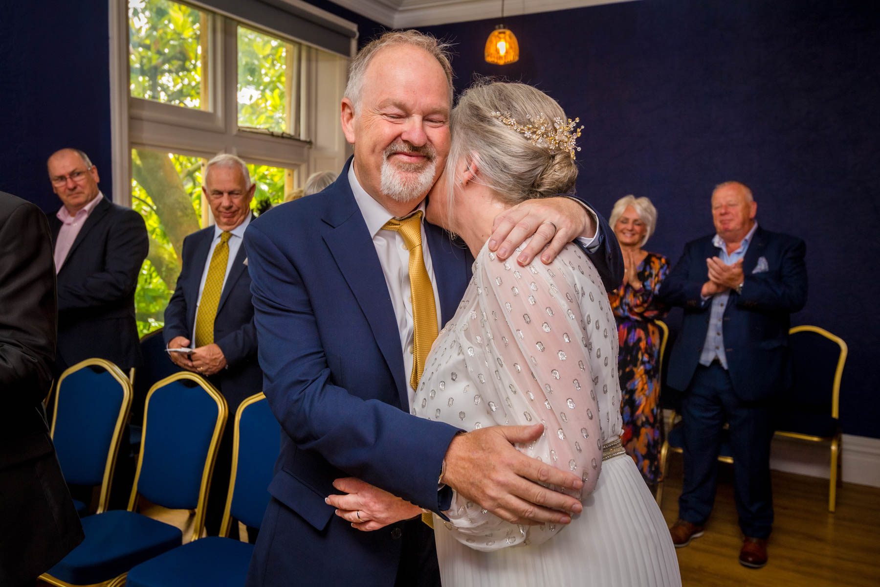 Bride and groom hug after wedding ceremony at Insole Court, Cardiff