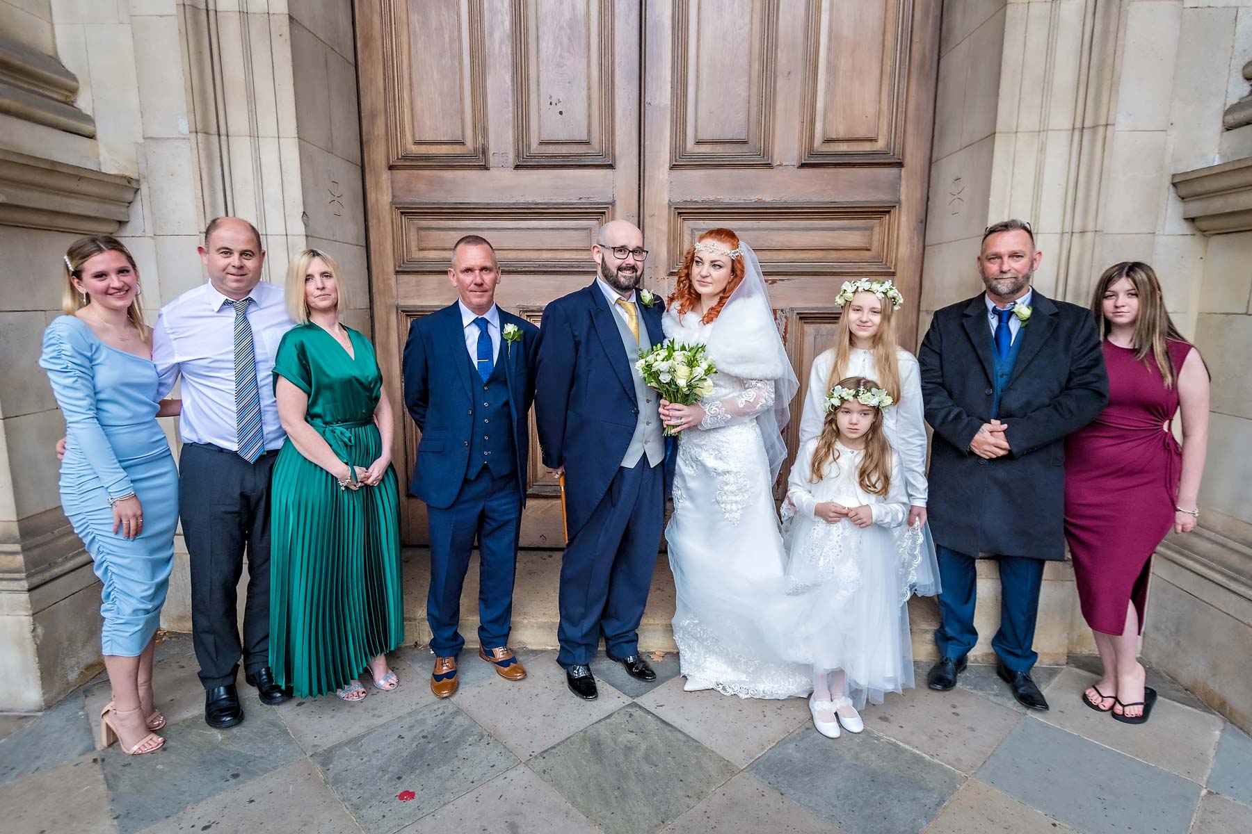 Guests posing with couple after their Brompton Oratory marriage