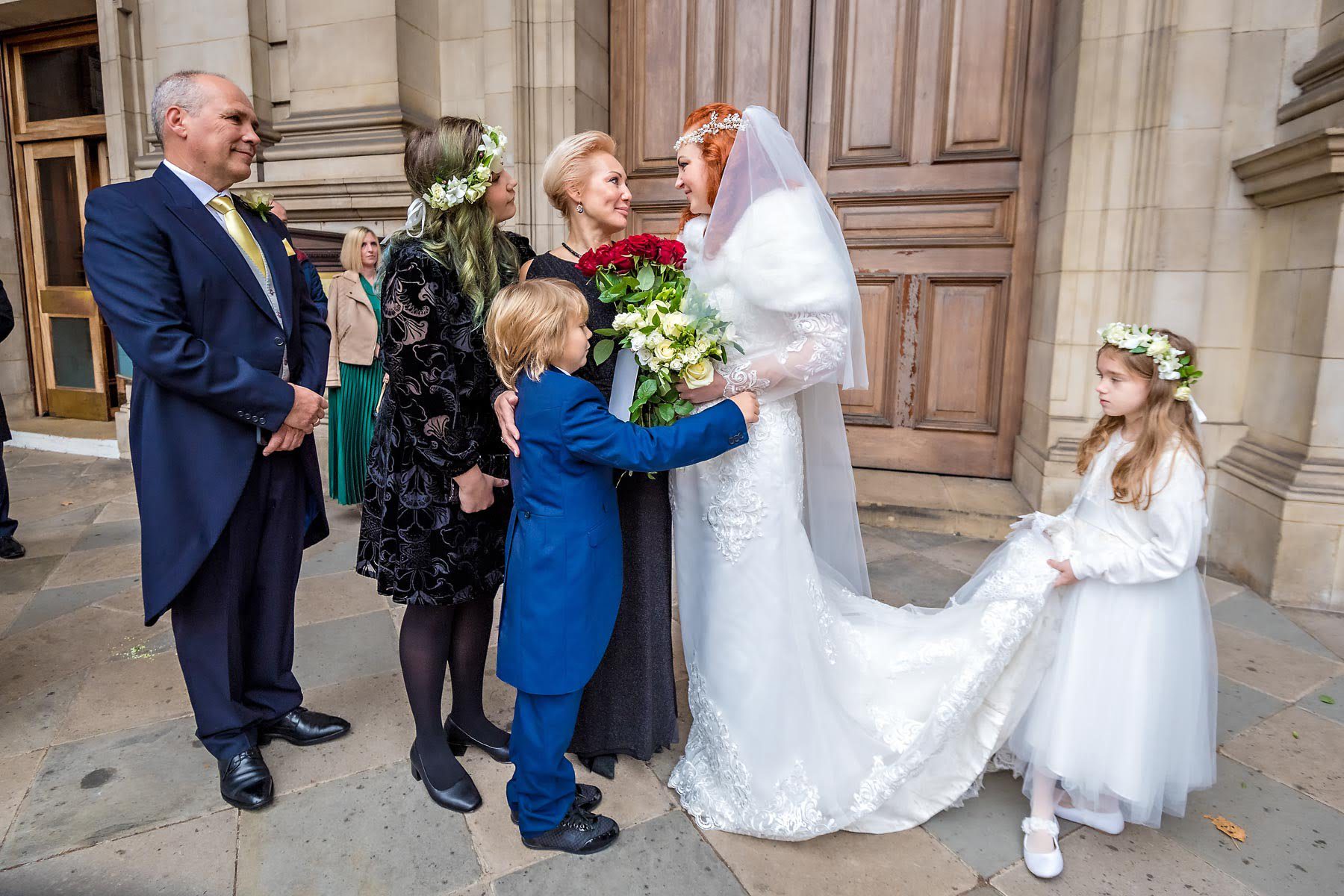 The bride chats with wedding guests outside her Brompton Oratory wedding in Knightsbridge