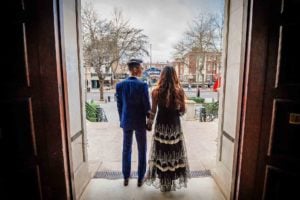 Newly-weds looking out of the door of Islington Town Hall onto Upper Street