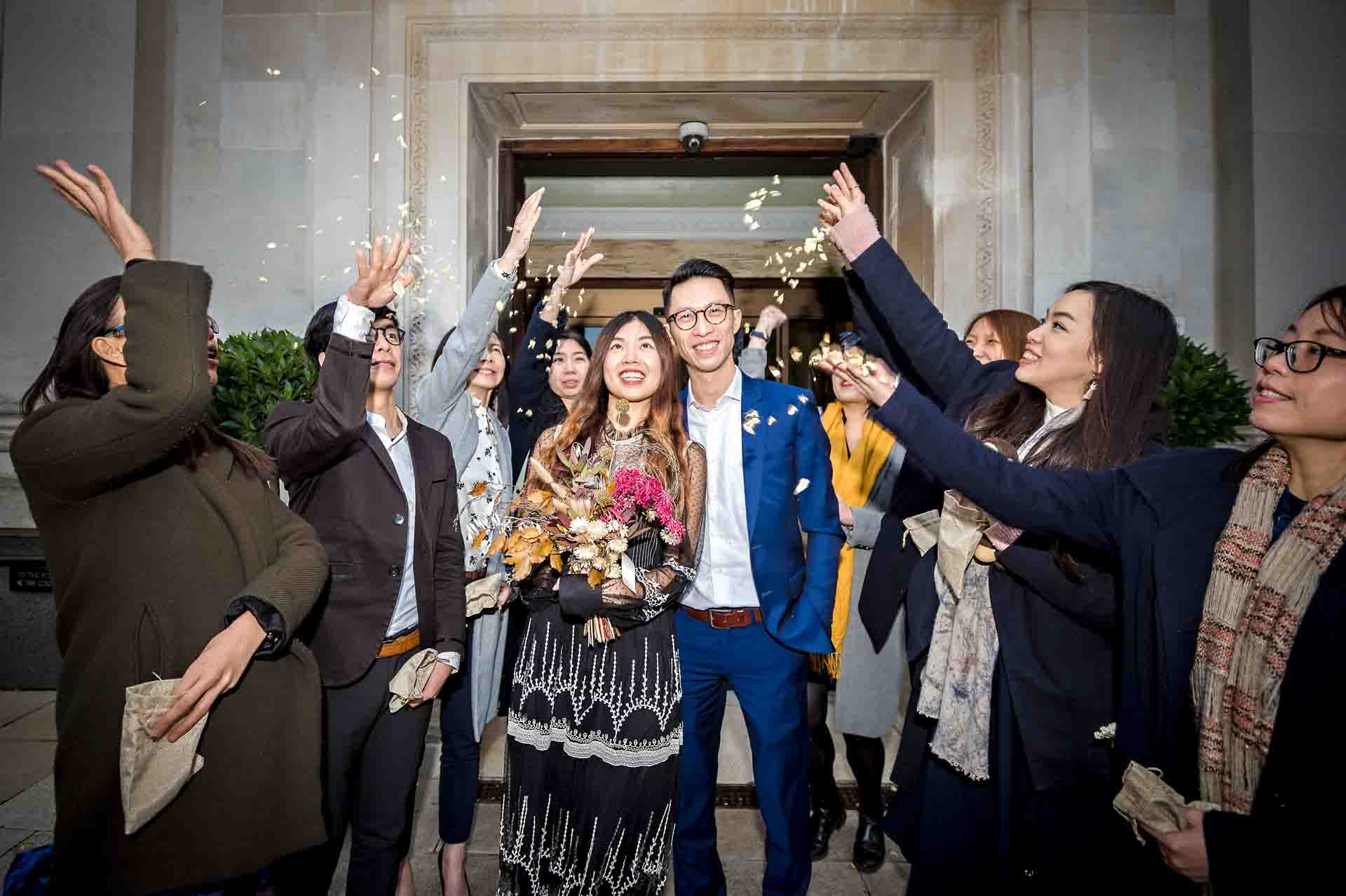 Chinese newly-weds leave Islington Town Hall in a shower of confetti