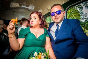 Couple on Wedding Bus Using Fan in Heat