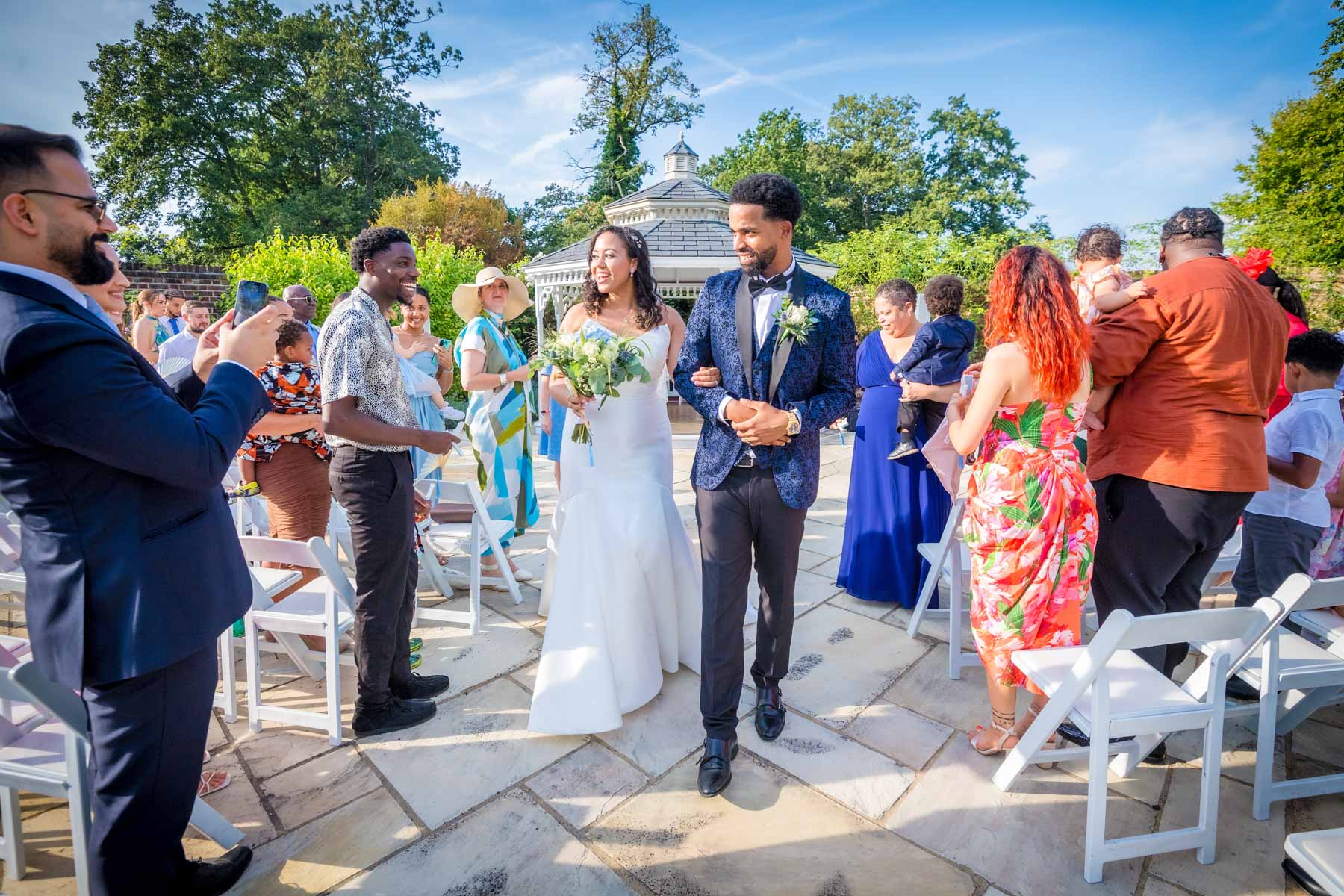 Couple walking back down aisle at outside wedding in Merton Register Office