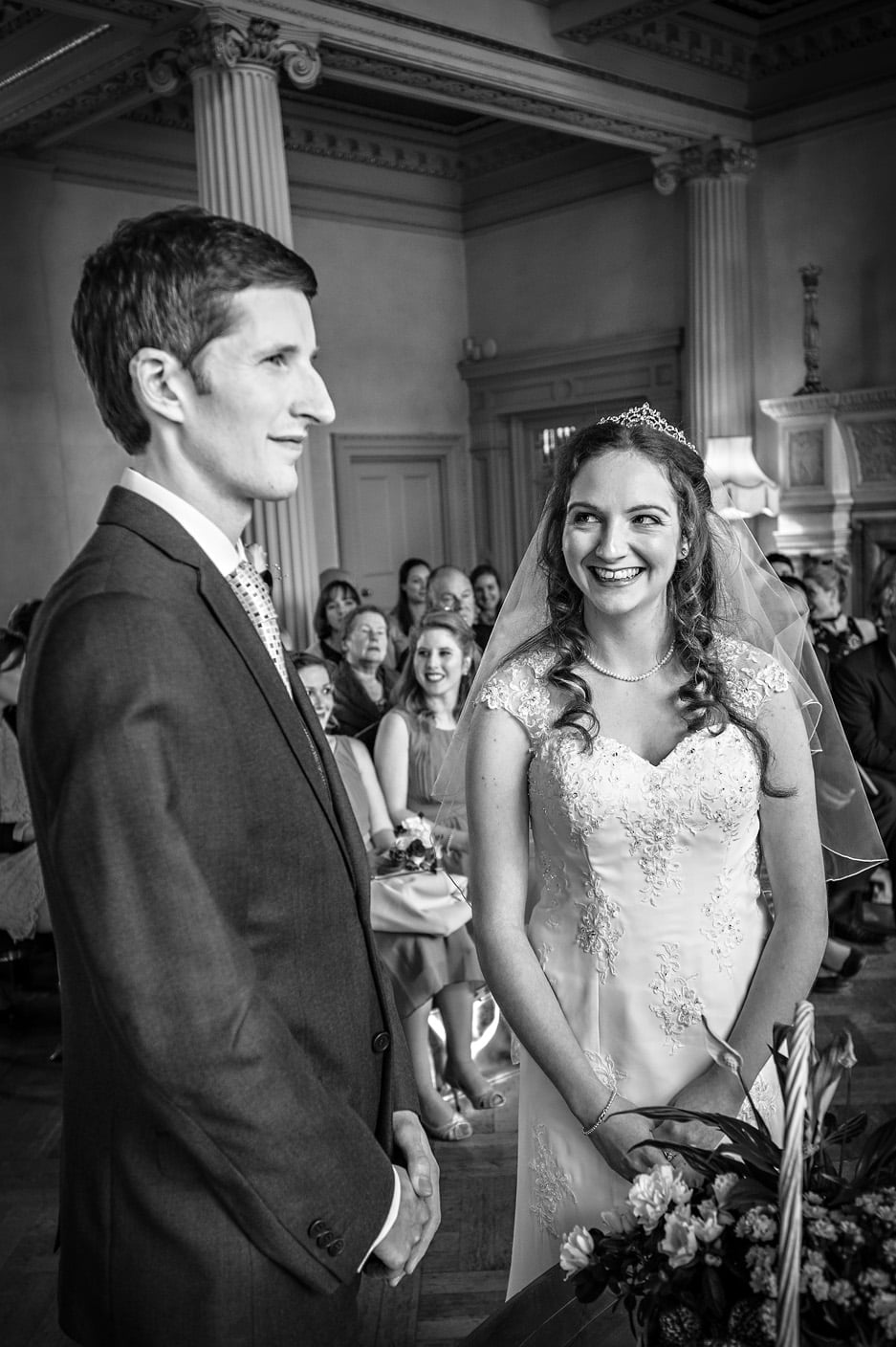 The bride laughing with groom at Hampton Court House wedding ceremony