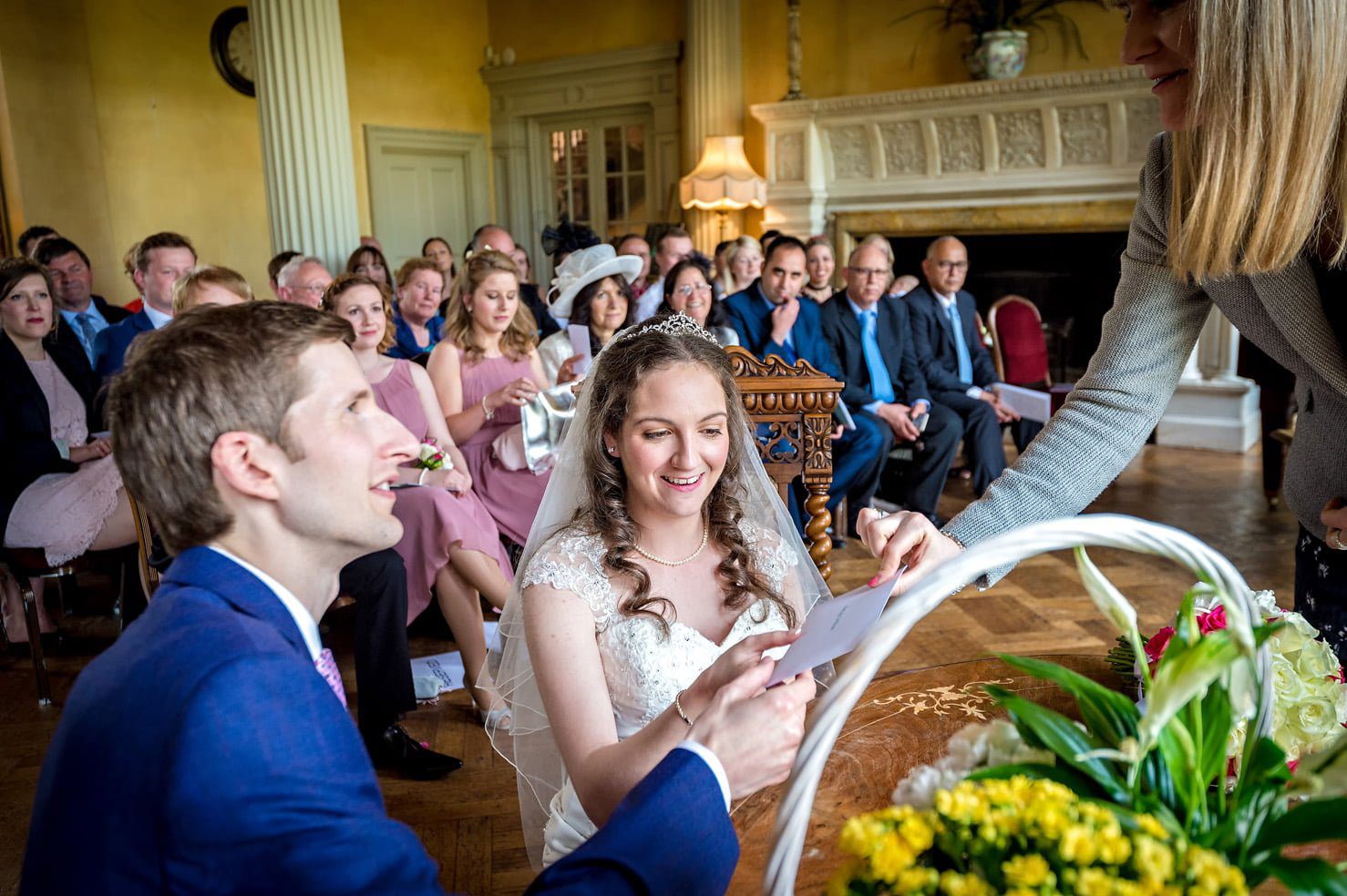 Registrar hands the marriage certificate to the couple after their vows at Hampton Court House