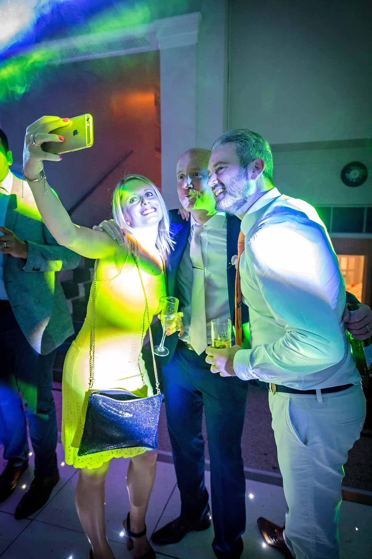 Groom having selfie with some wedding guests