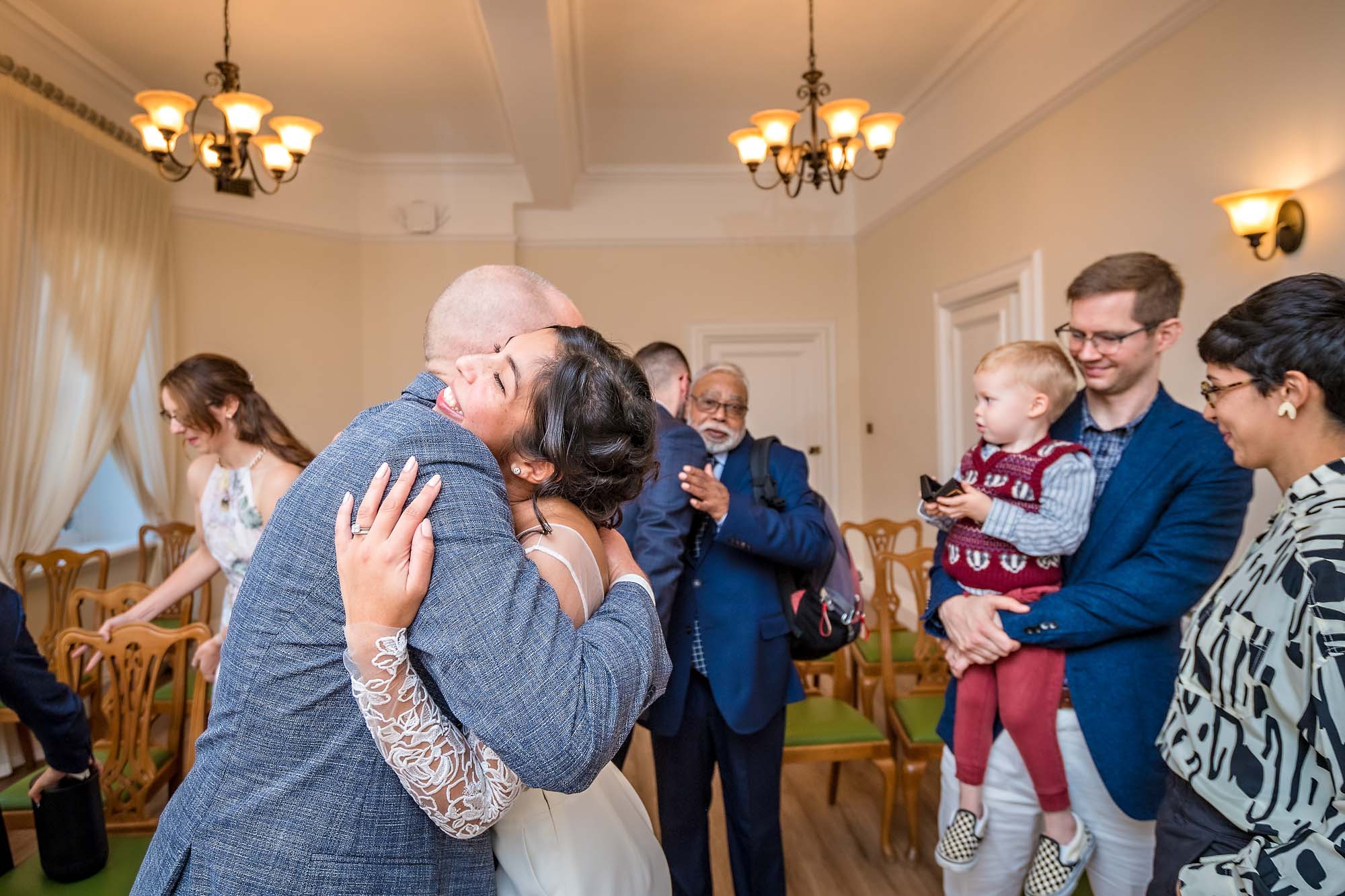 Bride hugging groom's father at London wedding