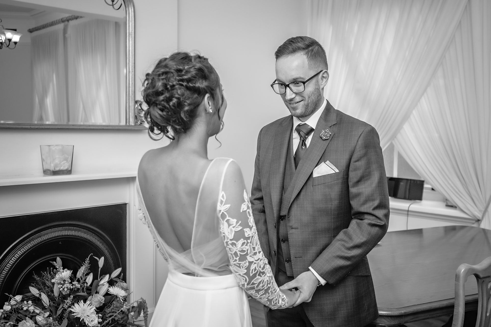 A happy groom looking at his bride in Woolwich Town Hall