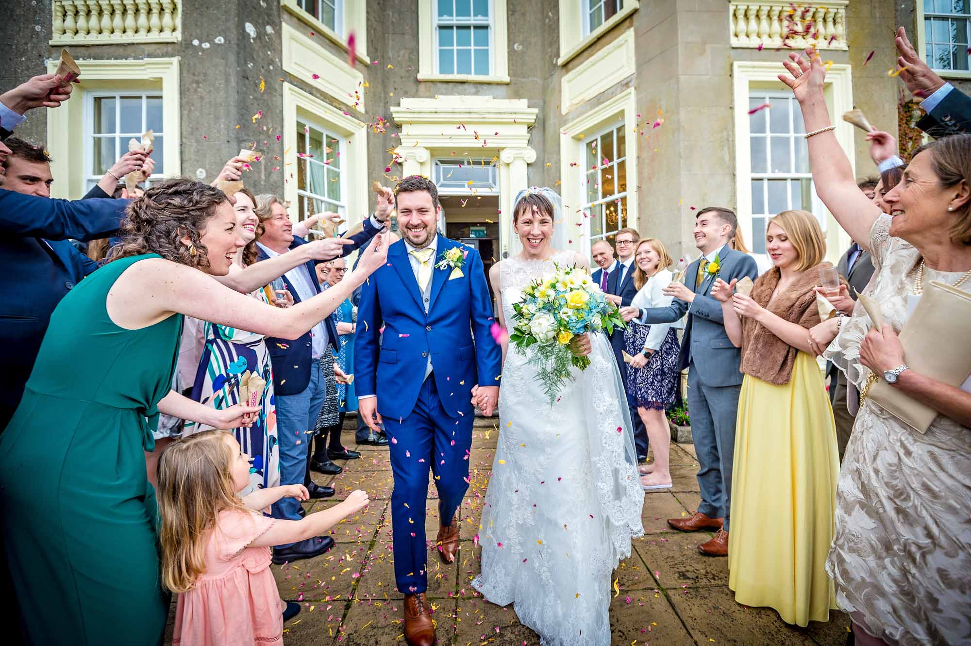 The happy couple exit the New House Country Hotel and are showered with confetti by guests