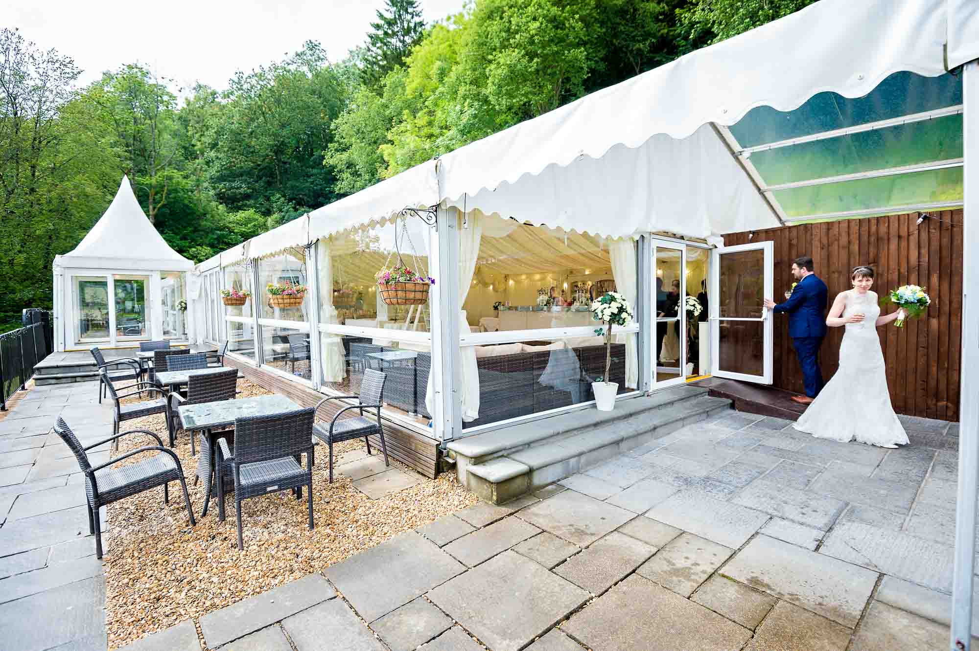 The bride and groom entering the Marquee at New House Country Hotel