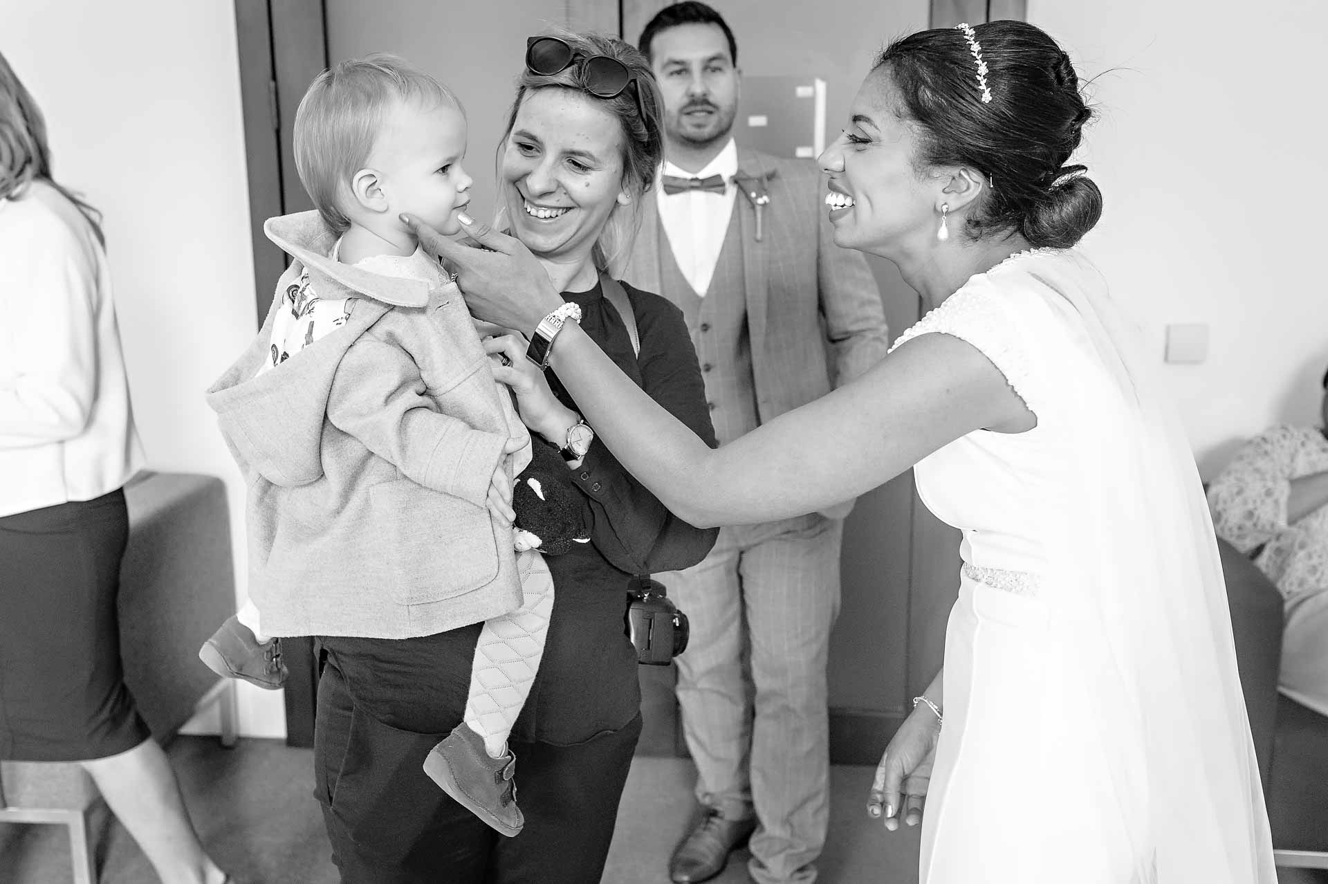 Bride Touching Toddler on Cheek