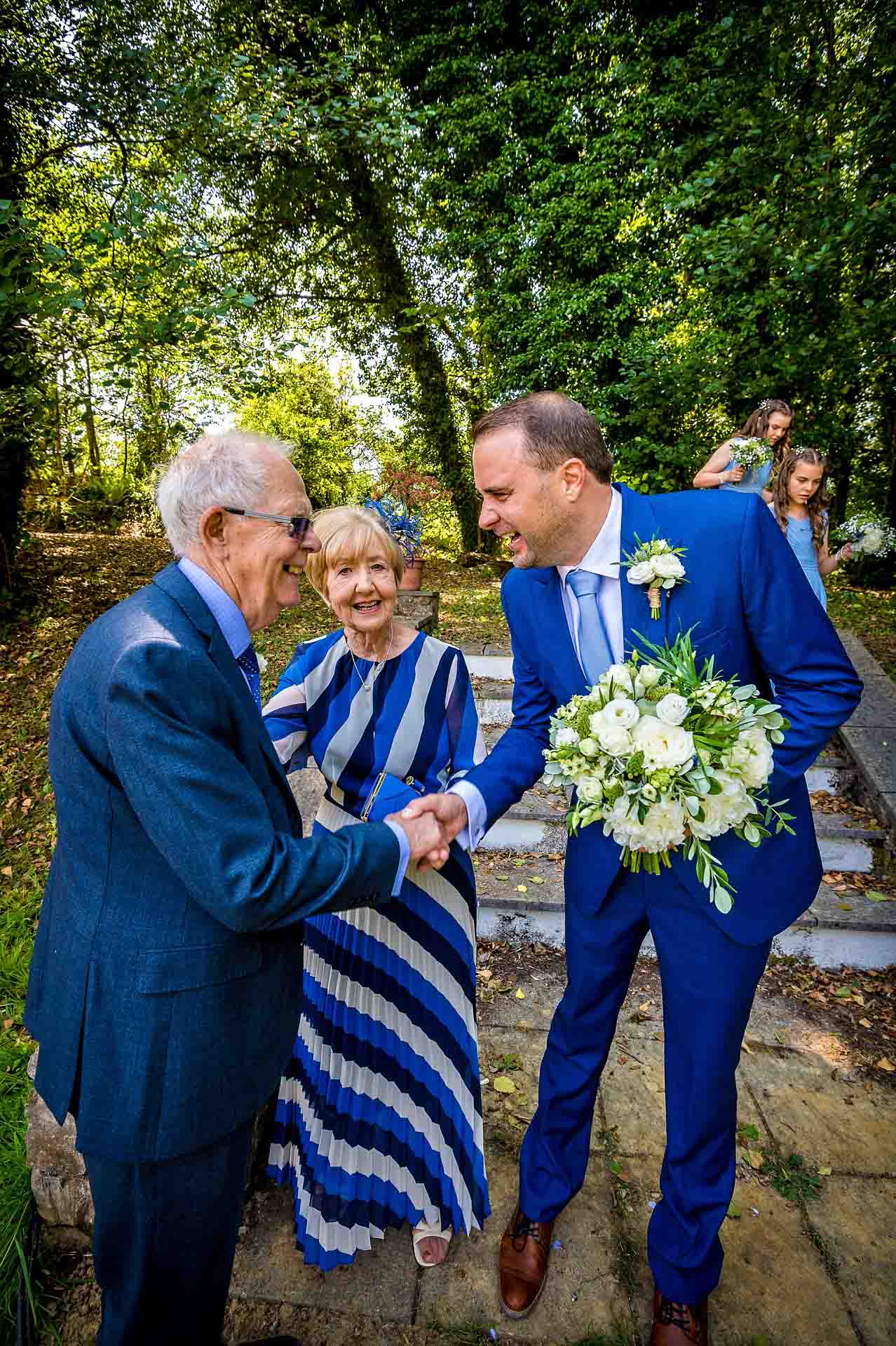 Bridegroom Being Congratulated by Guests at Pencoed House Cardiff