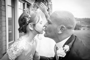 Groom and father Kissing Bridesmaid