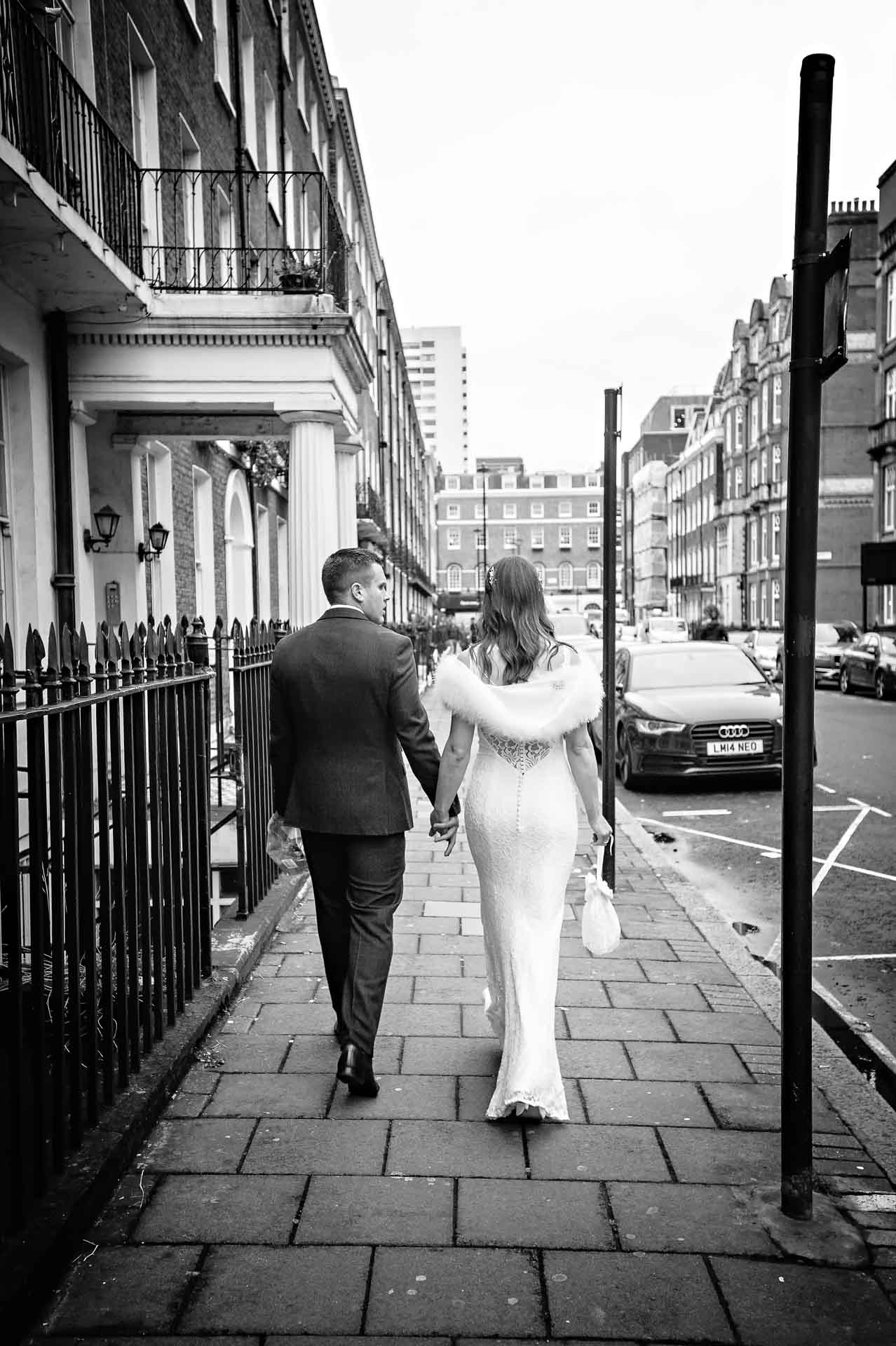 Couple in Wedding Clothes Walking Taken from the Back