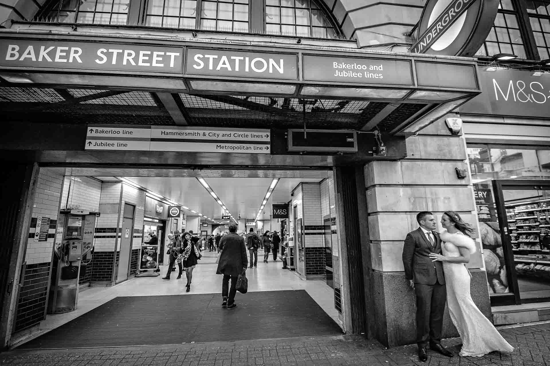 Wedding couple outside Baker Street Station in London with passers by