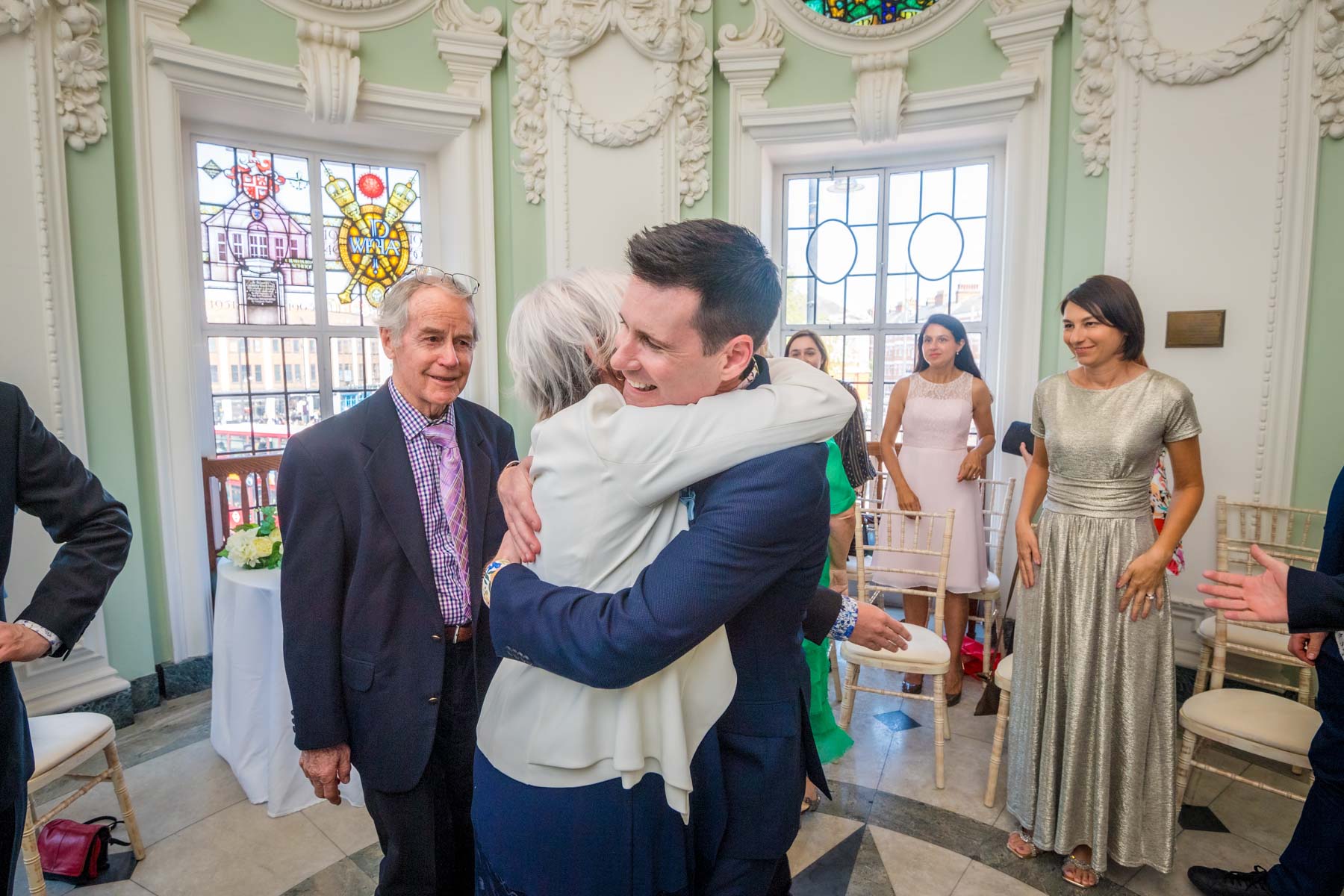 The groom's mum hugs him after a wedding at Lambeth Town Hall in Brixton