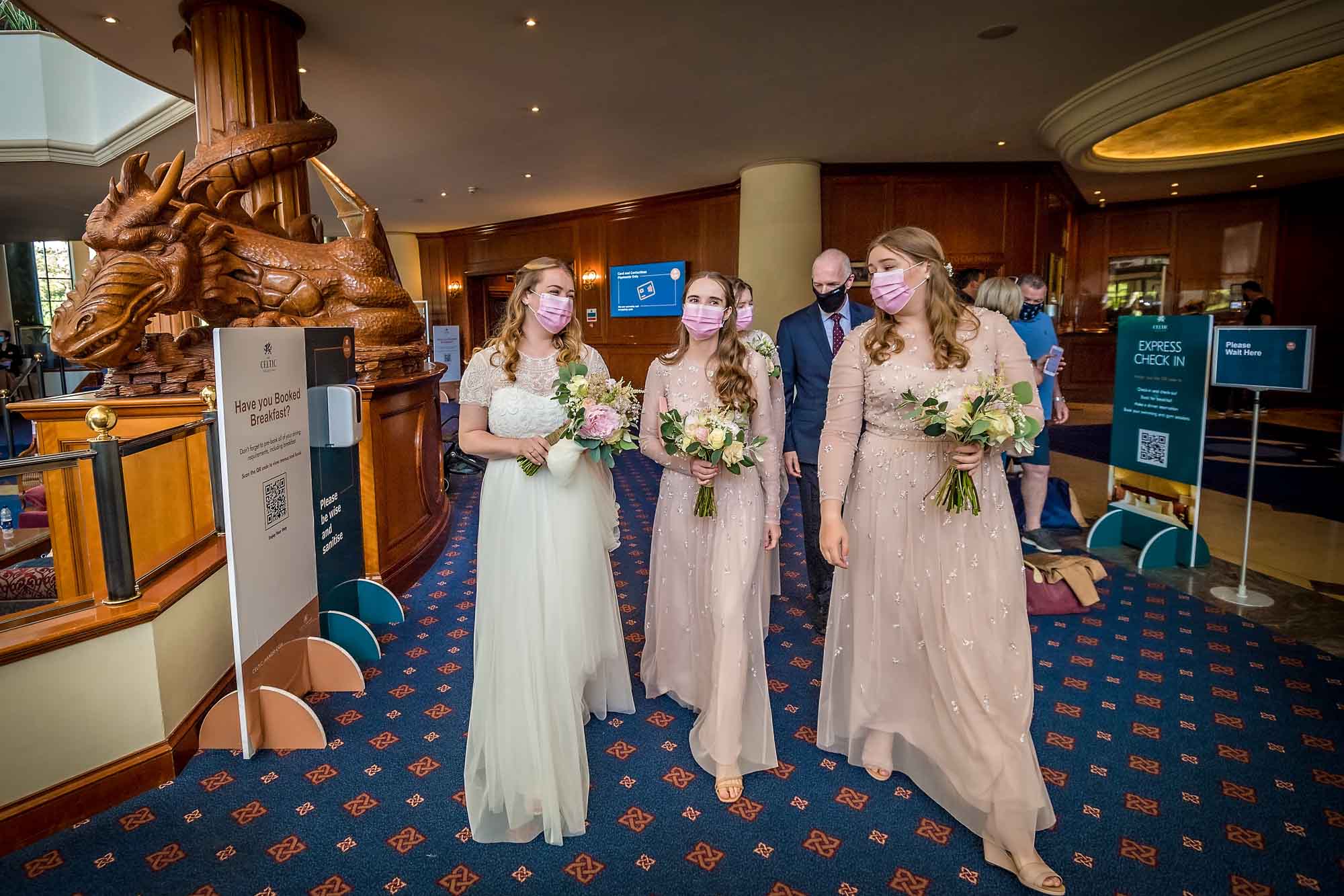 The masked bridal party walk through reception at Celtic Manor Resort