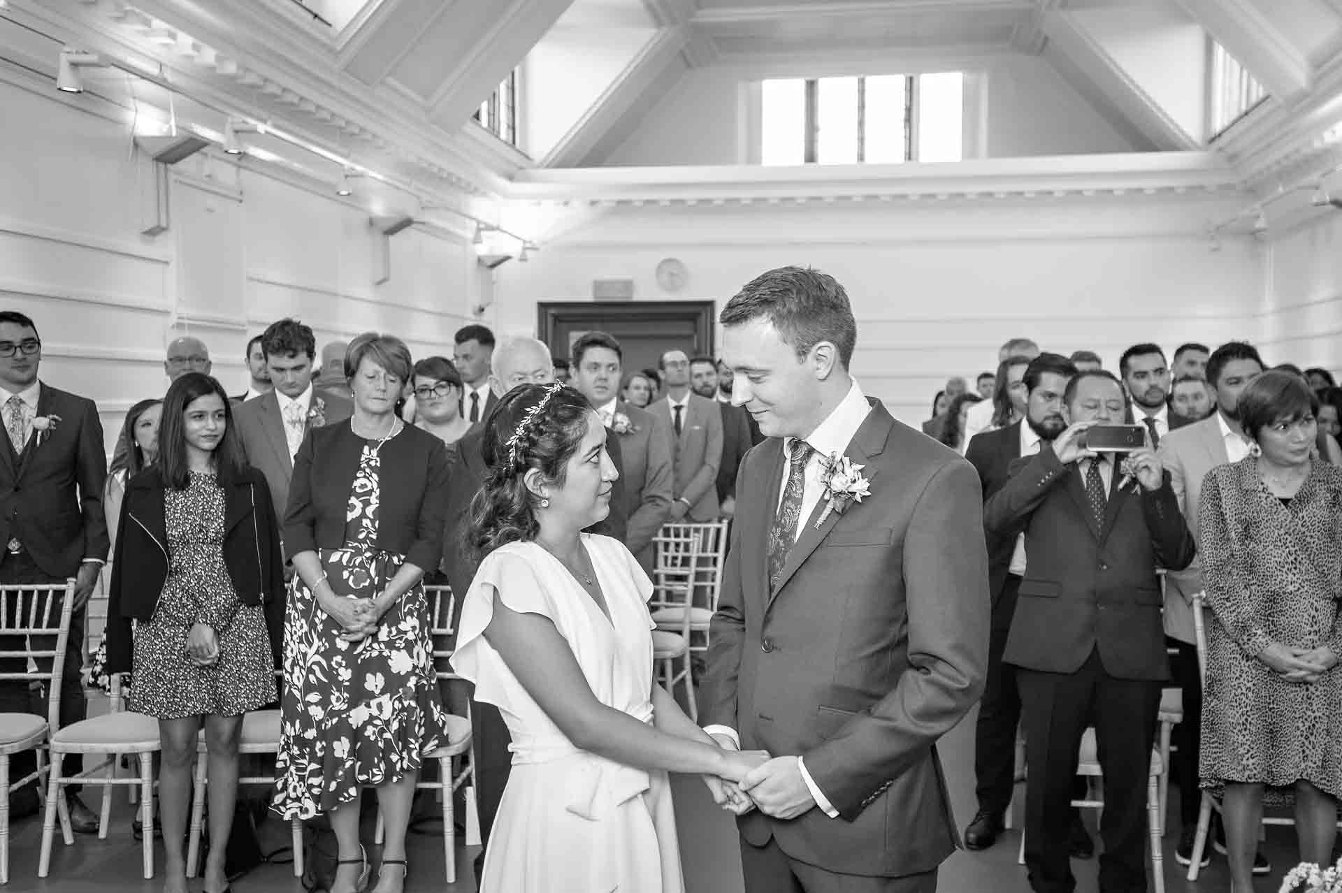 Couple gazing at each other following exchange of rings at Fulham Library